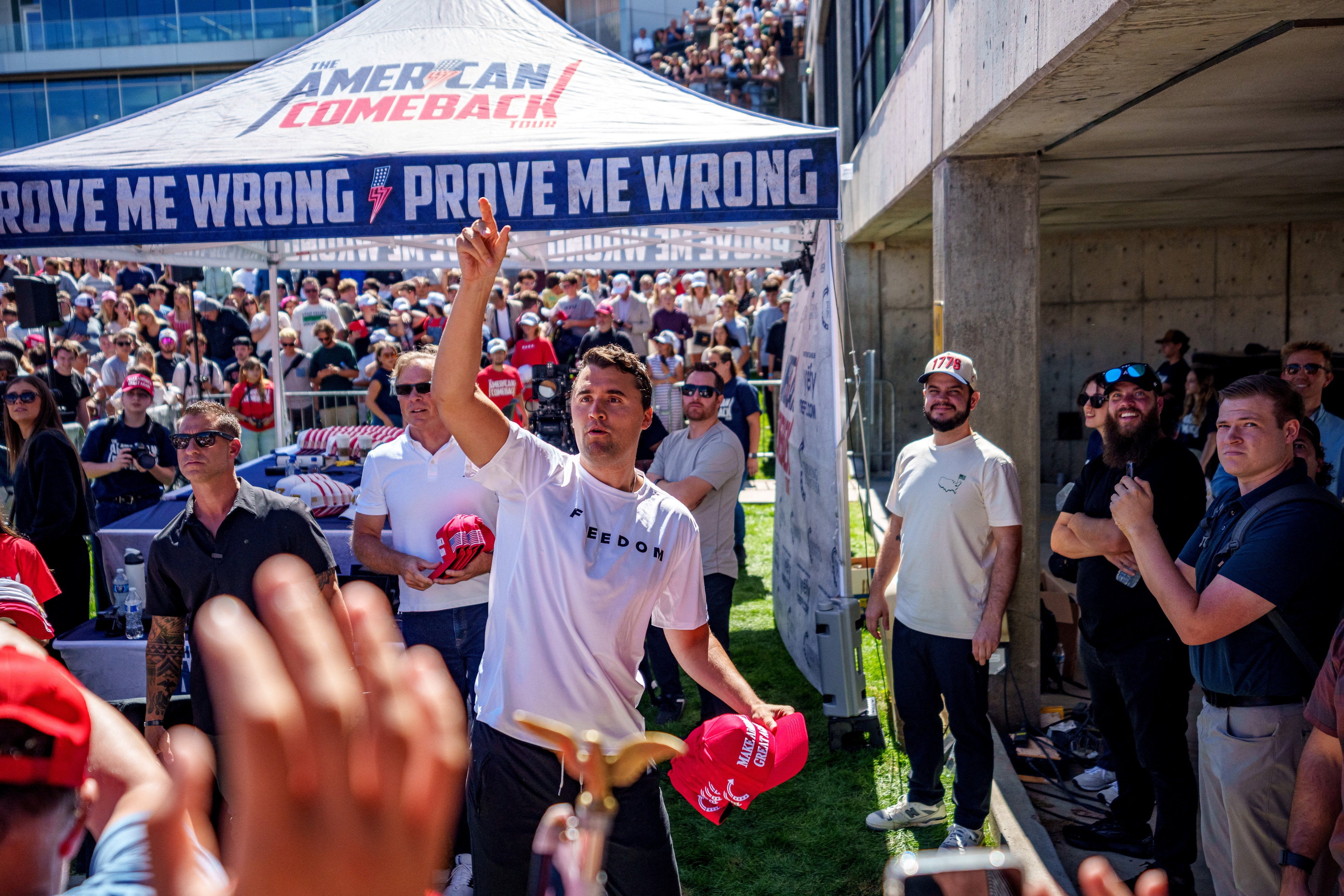 Right-wing activist and commentator Charlie Kirk throws hats to the crowd shortly before he was shot at a Utah Valley University speaking event