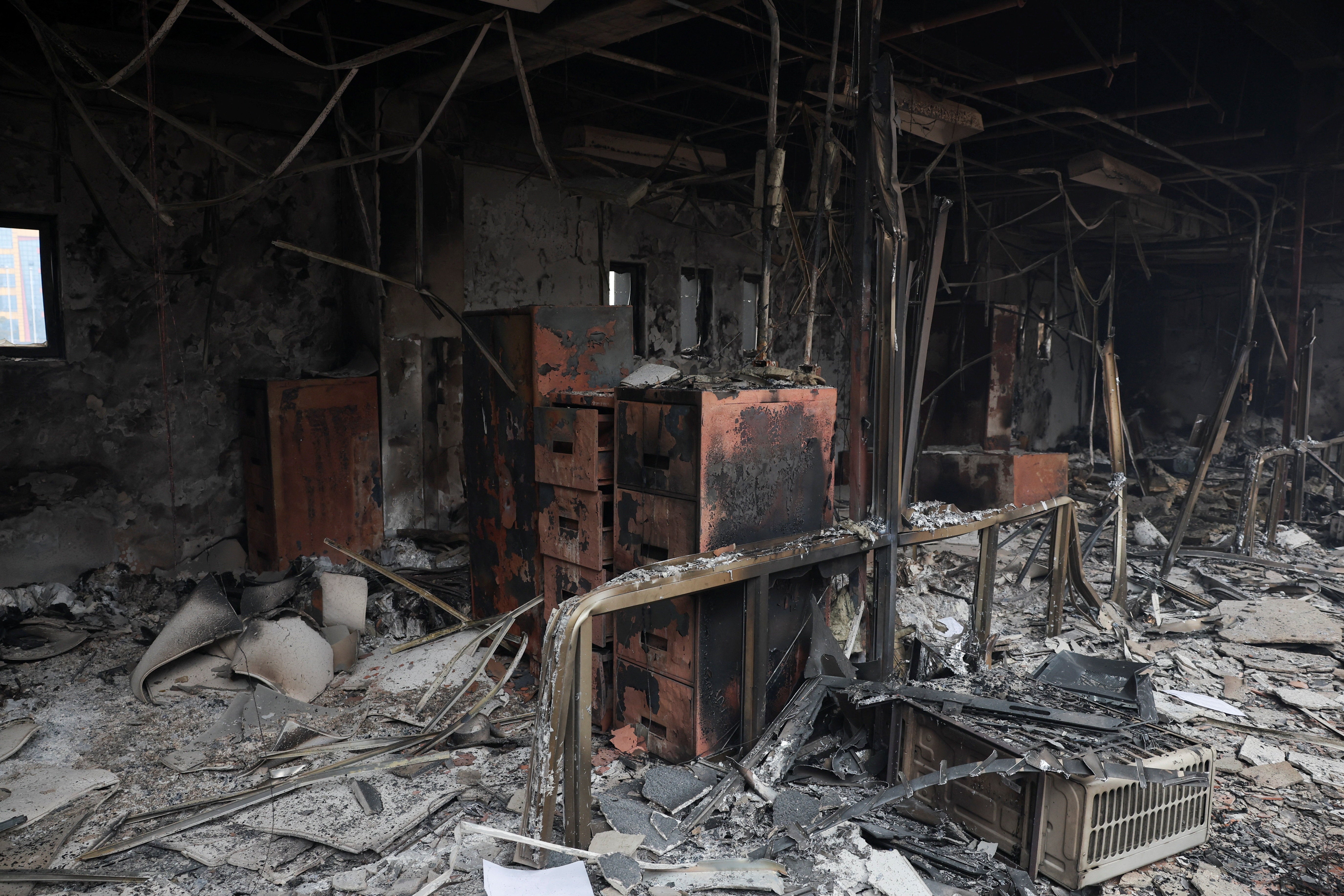 Burnt remains lie inside a section of the parliament house, which was set on fire by the protesters