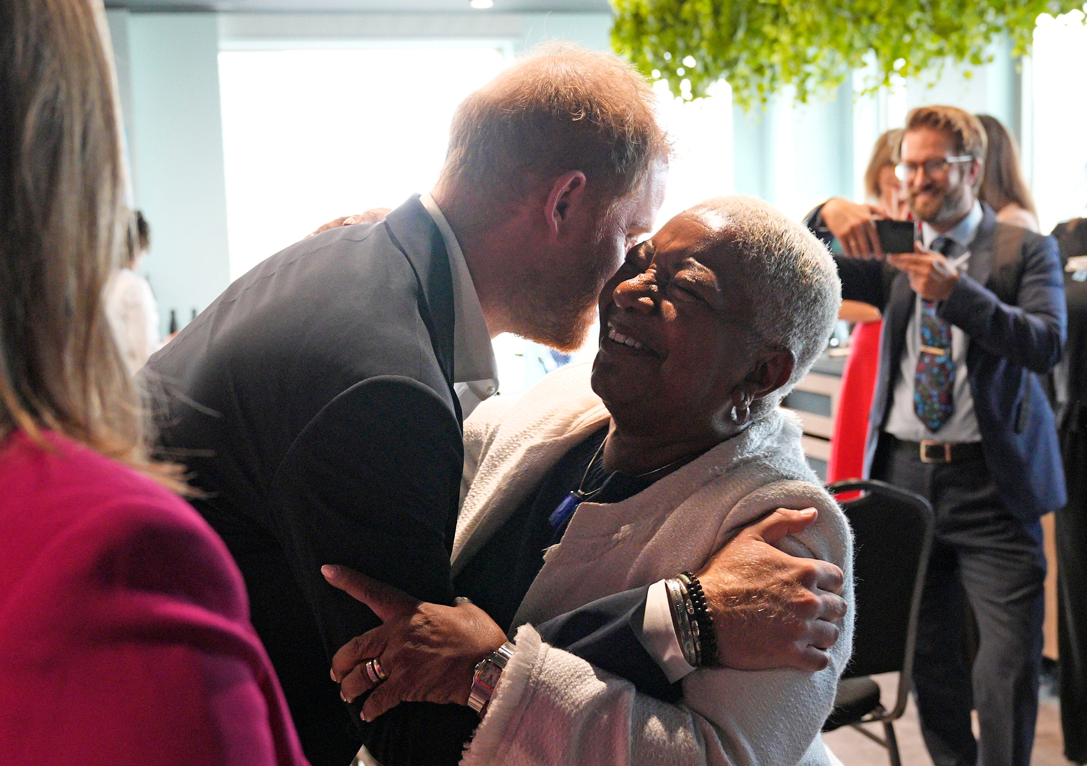 The Duke of Sussex hugs Colleen Harris, a trustee of the king Charles III charitable fund
