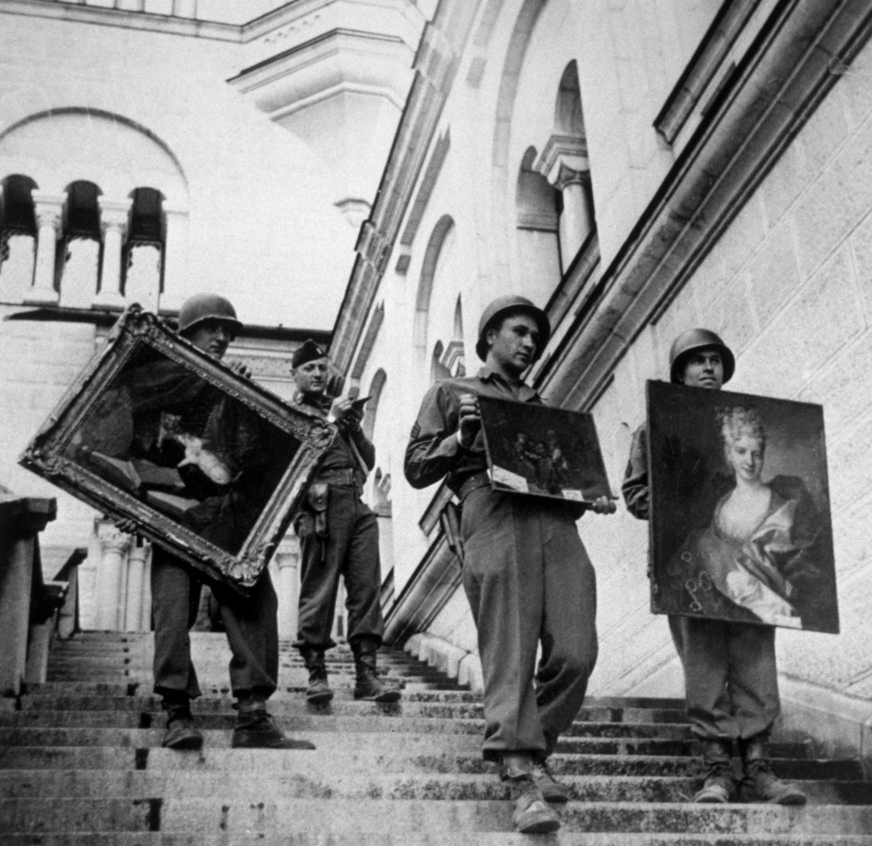 US soldiers carry some of the priceless collection of stolen paintings discovered hidden in Neuschwanstein Castle in Bavaria, in May 1945