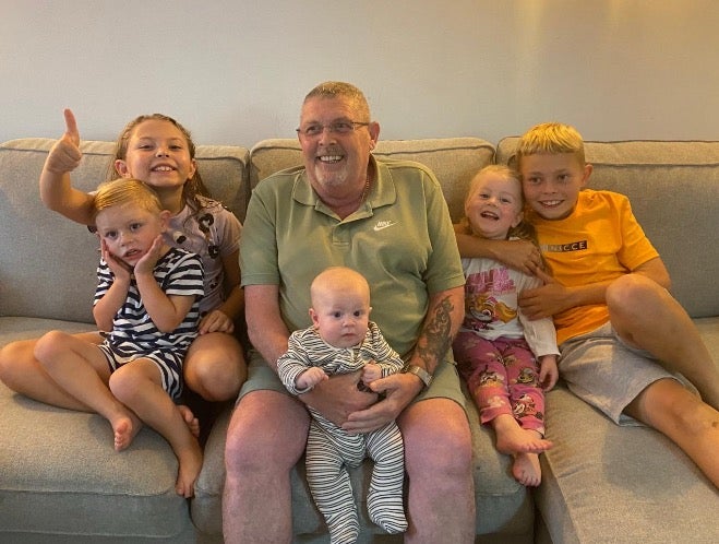 Terry Harper, 62, pictured with his grandchildren, was diagnosed with multiple myeloma in 2022 after suffering with back pain for months
