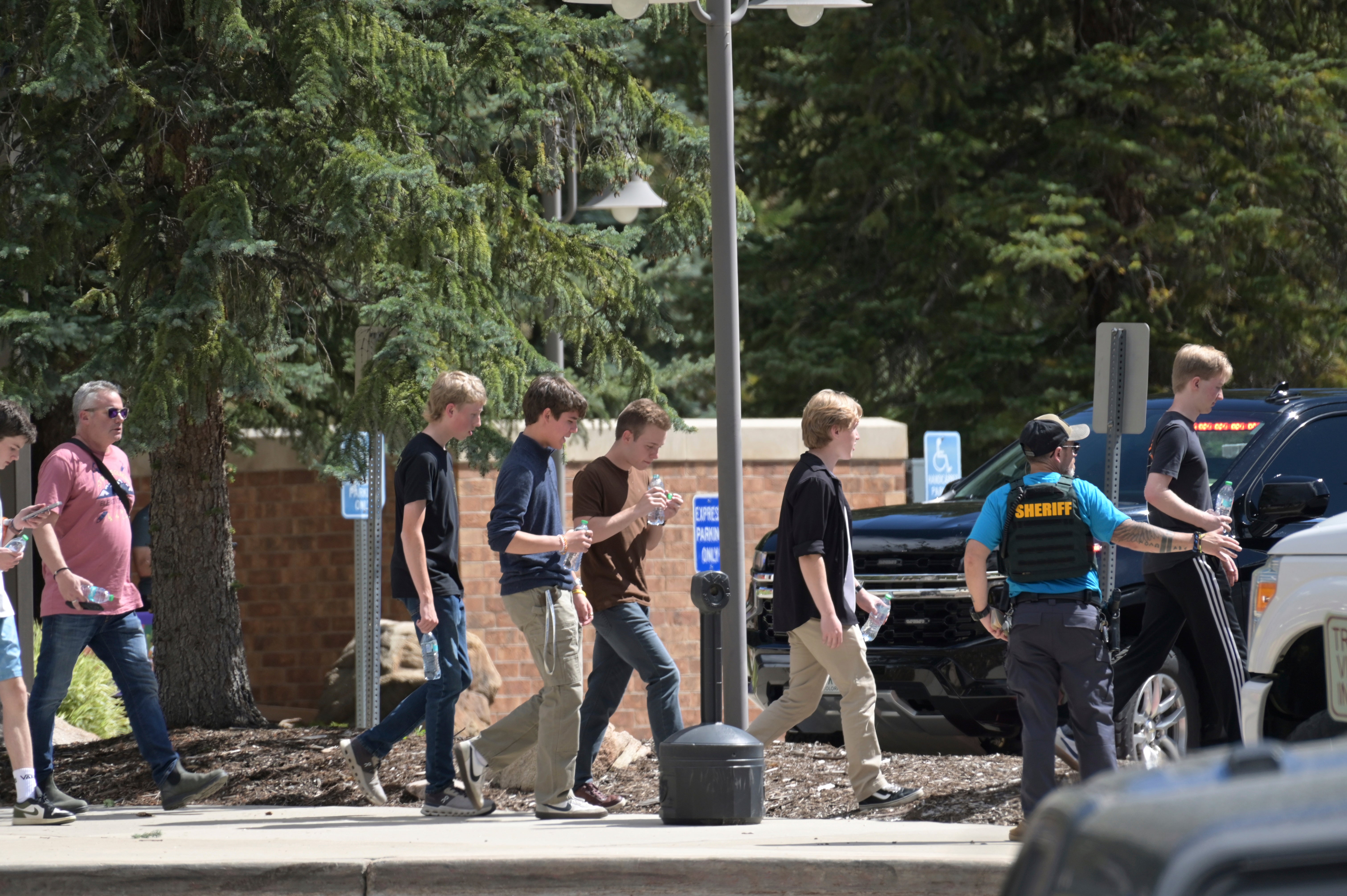 Students were escorted to board a bus after a shooting at Evergreen High School in Evergreen