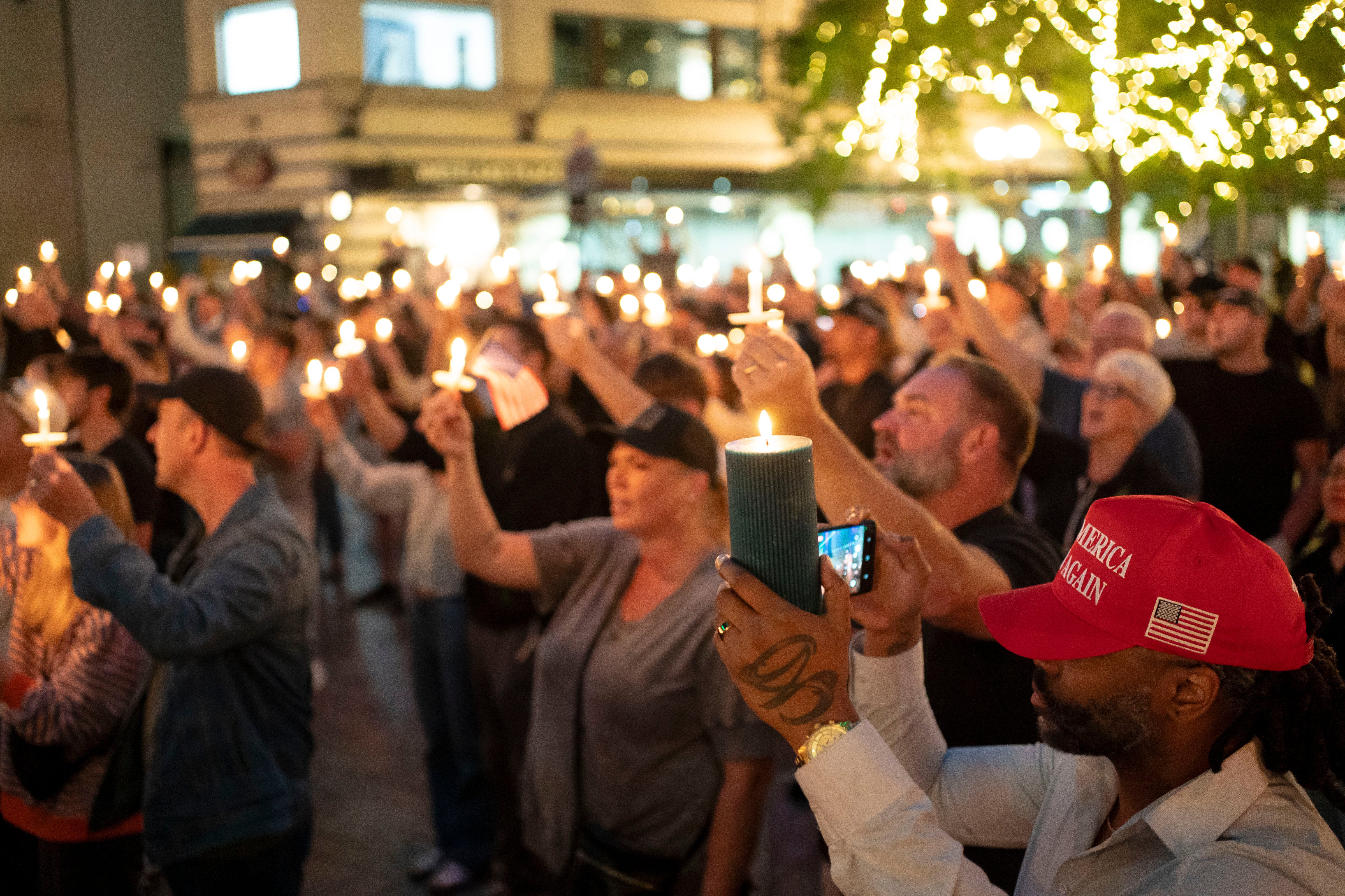 Mourners in Seattle, Washington, hold a candlelit vigil for Kirk on Wednesday evening