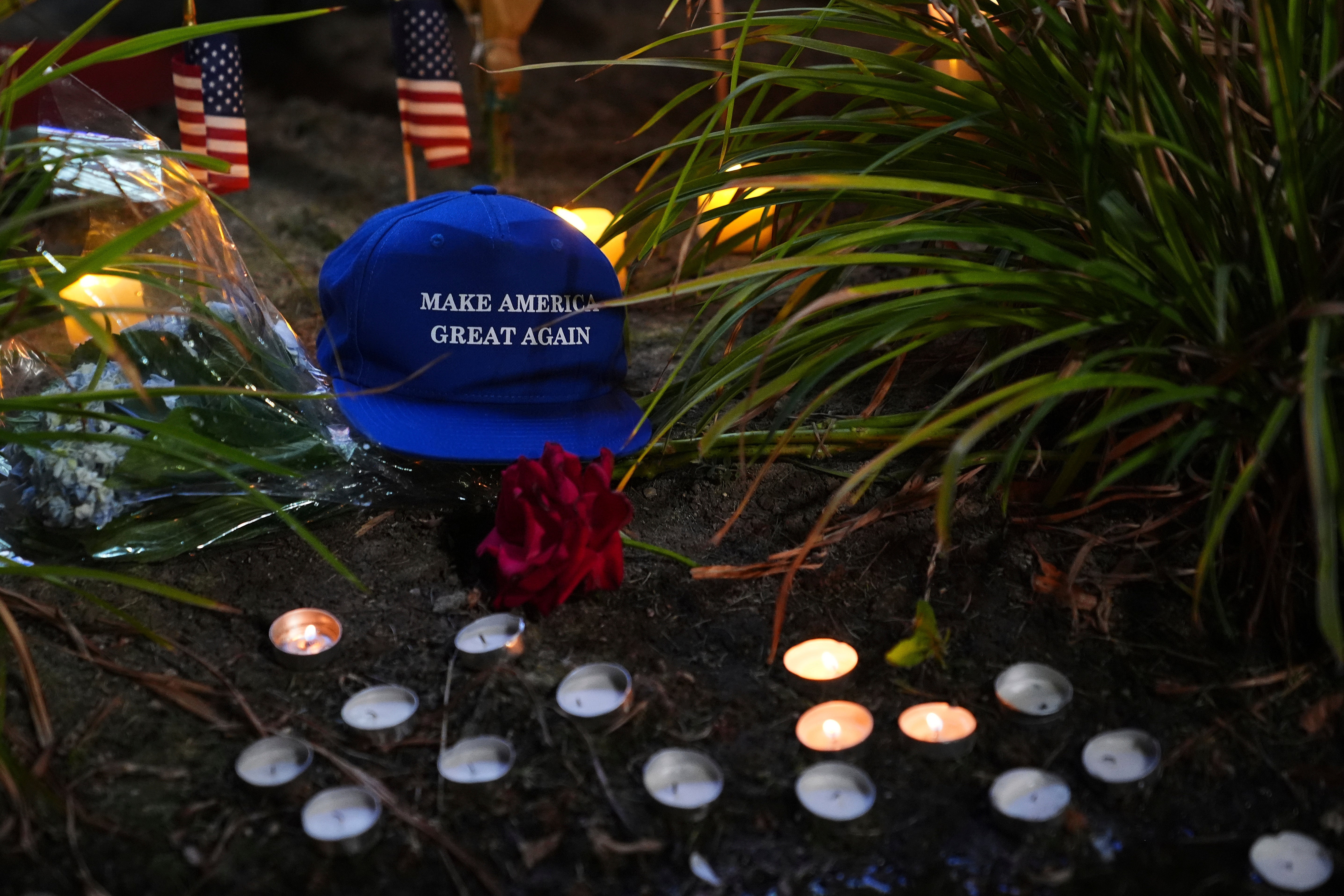 A Make America Great Again hat is placed at a growing vigil outside Timpanogos Regional Hospital after Charlie Kirk was shot and killed