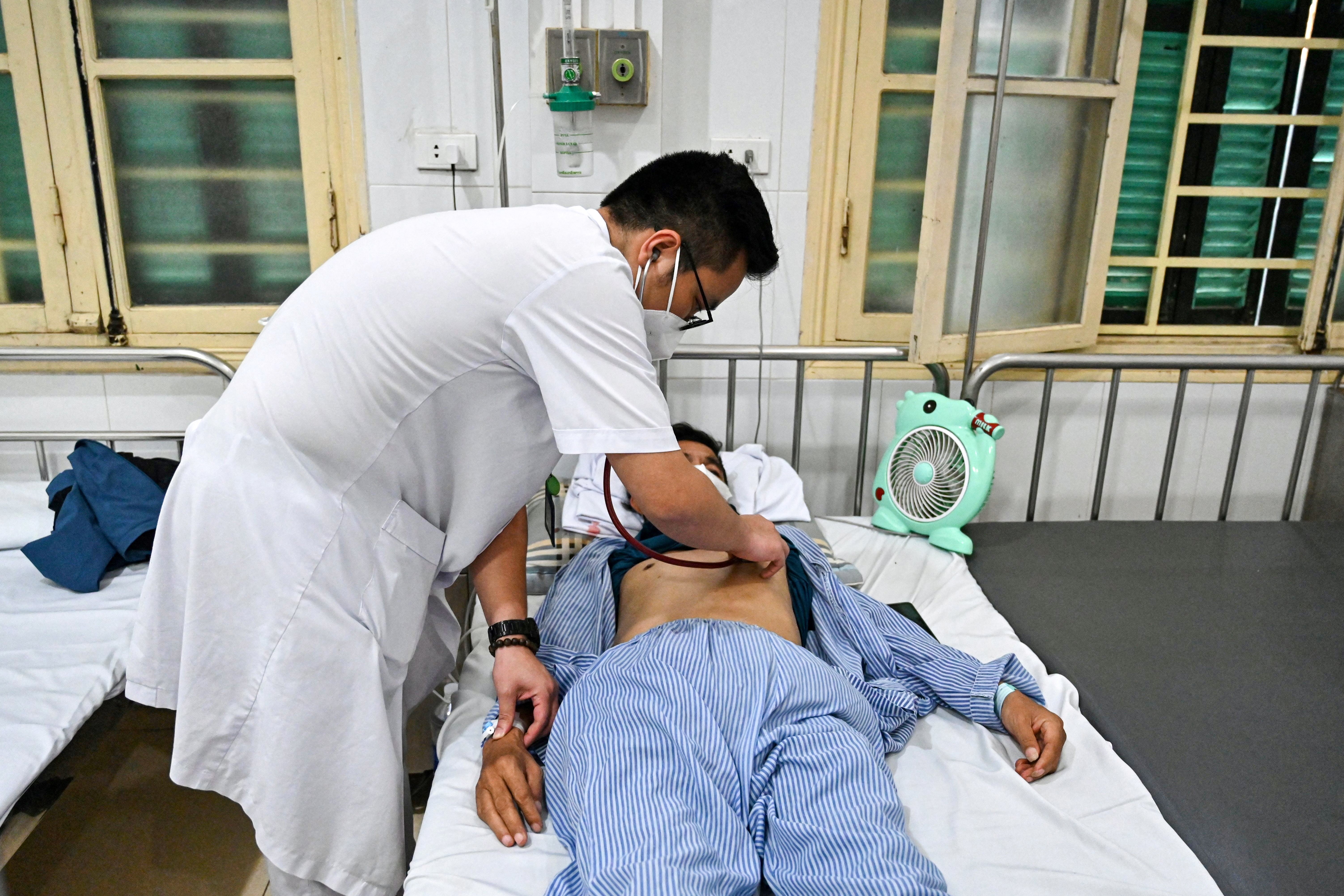 A Vietnamese doctor checks a tuberculosis patient