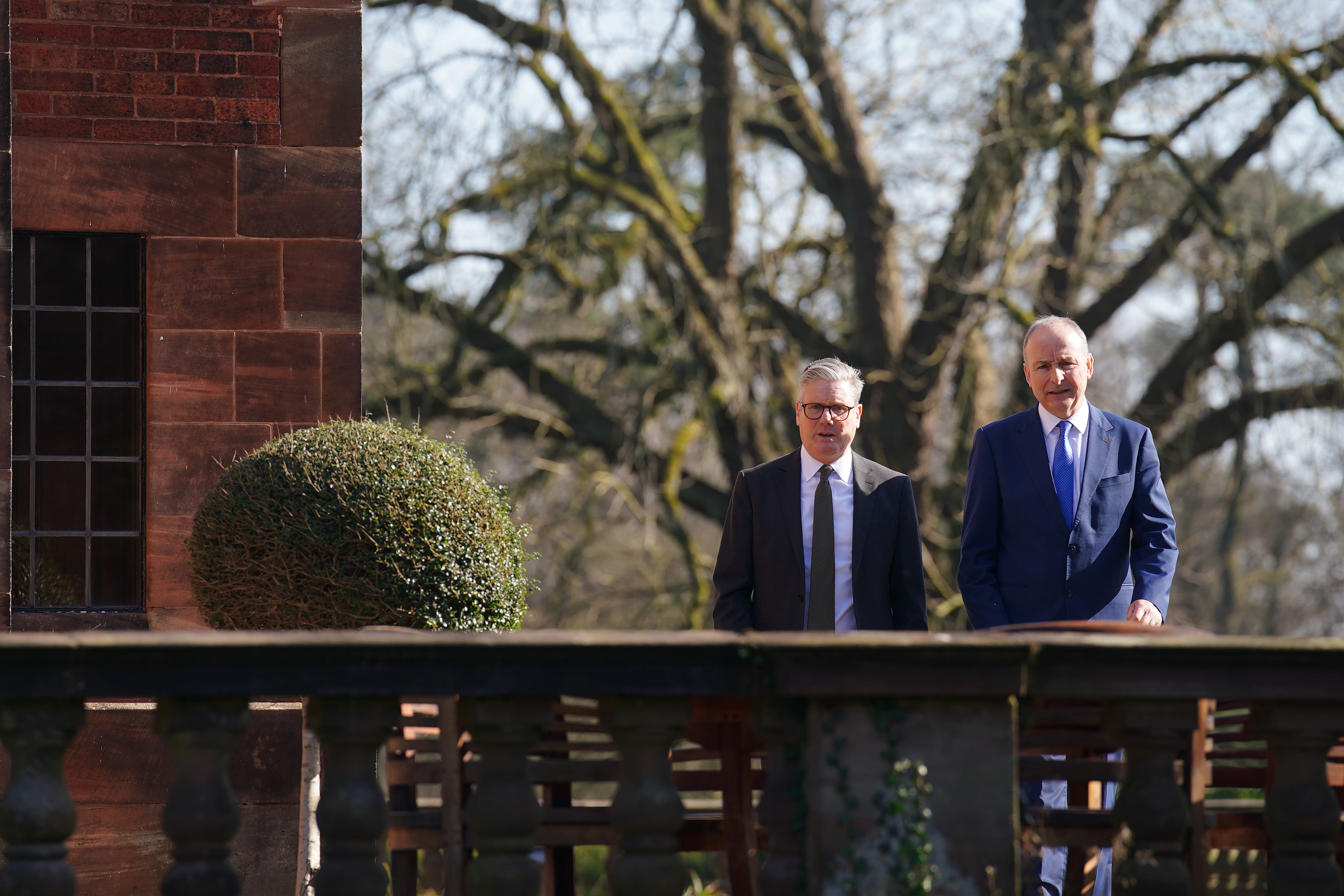 Prime Minister Sir Keir Starmer (left) walks with Taoiseach Micheal Martin in the gardens during a summit at Inglewood Manor House in Ellesmere Port, in the first in a new series of annual UK-Ireland summits taking place in Britain (Peter Byrne/PA)