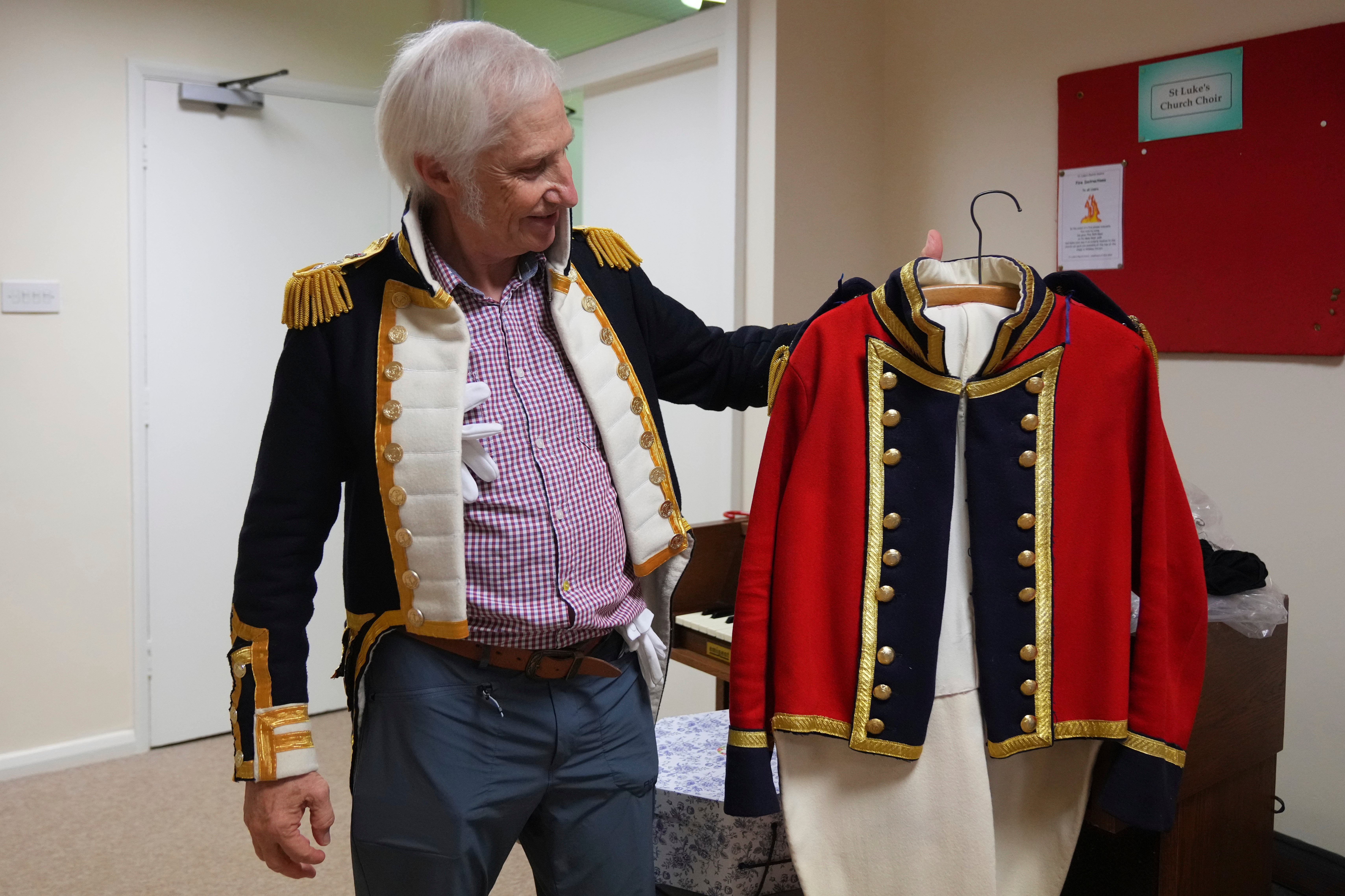 Chris Oswald, chair of the Hampshire Regency Dancers, holds up a period costume he made during a dance practice session of Hampshire Regency Dancers in Winchester, England, Sept. 10, 2025. (AP Photo/Joanna Chan)