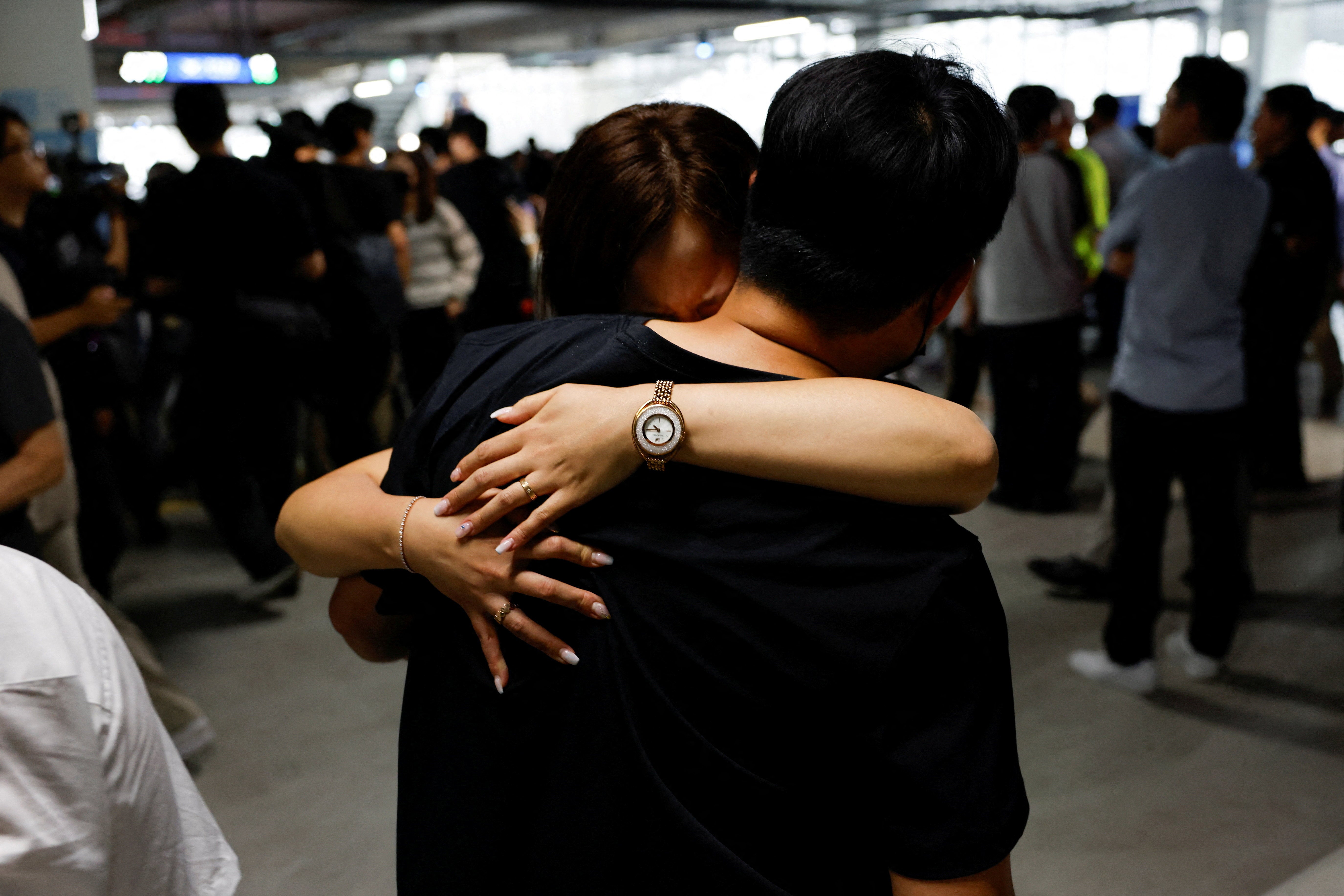 A returning South Korean worker hugs a family member at the Incheon airport
