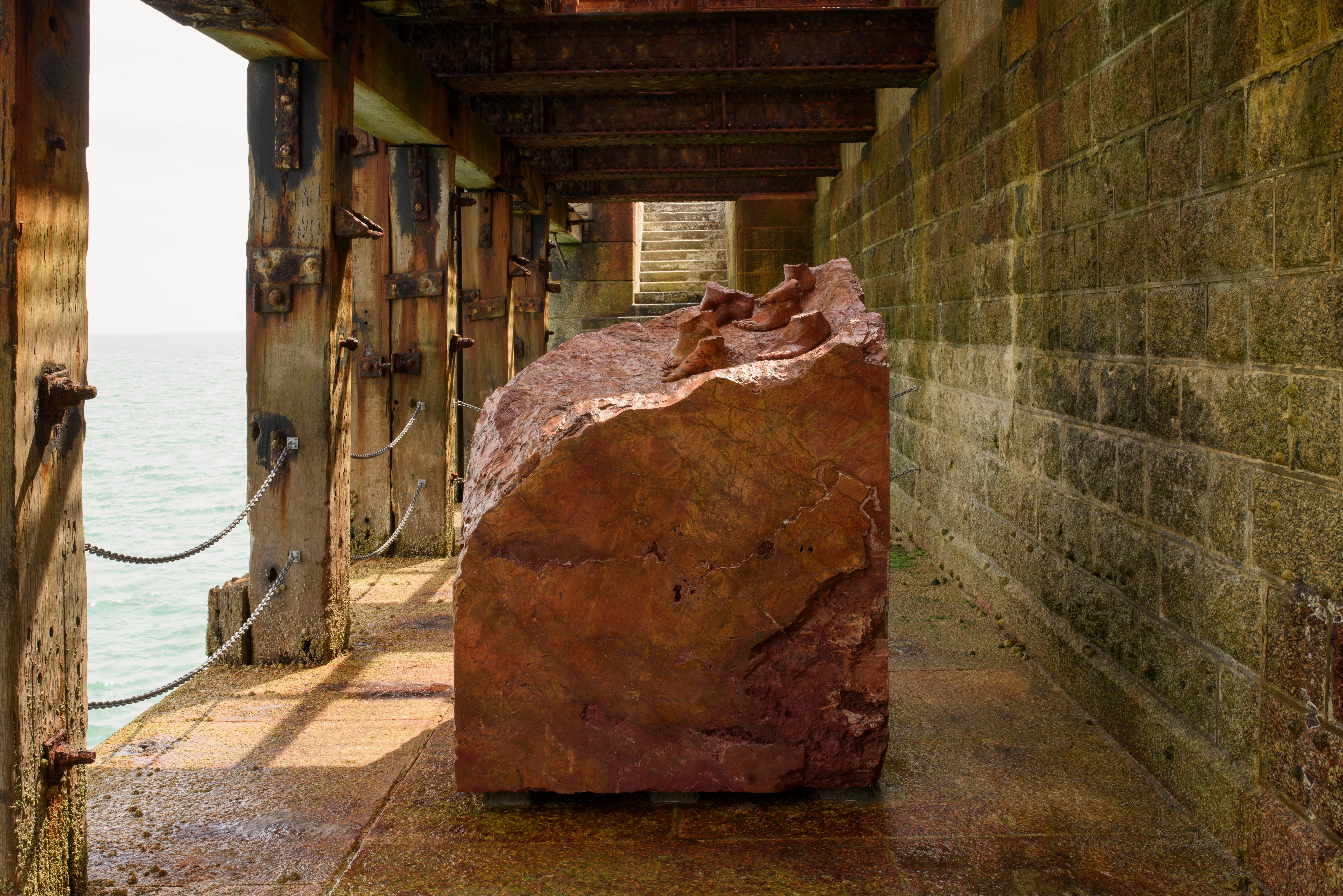 Dorothy Cross’ Red Erratic feet sculpture sitting on the Harbour Arm