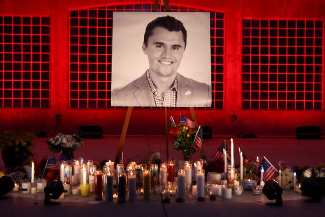 <p>Candles and flowers are placed near an image of Charlie Kirk at a vigil in Orem, Utah</p>
