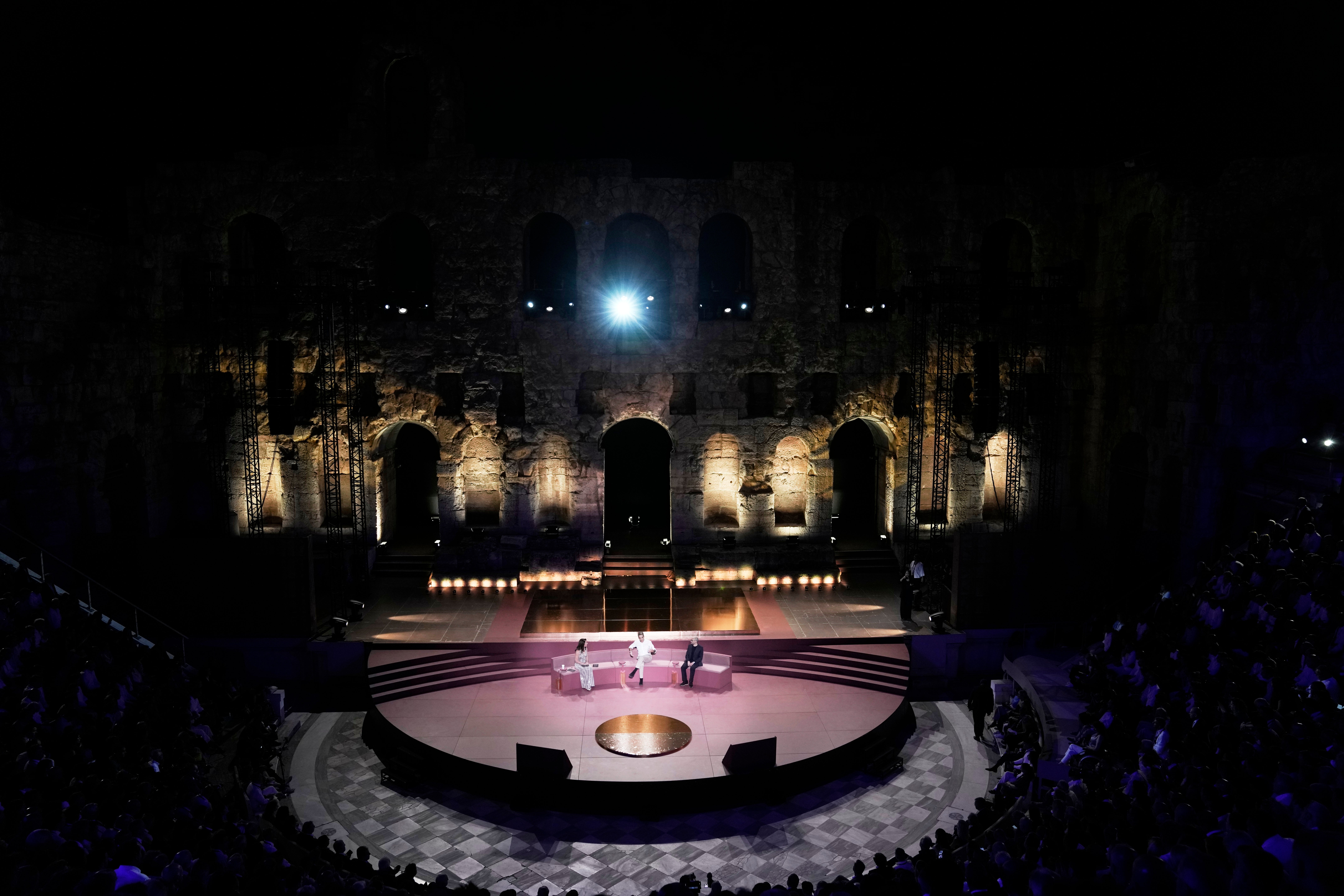 Greece's Prime Minister Kyriakos Mitsotakis, center, and Demis Hassabis, CEO of Google's artificial intelligence research company DeepMind, right, discuss the future of AI, ethics and democracy as the moderator Linda Rottenberg, Co-founder & CEO of Endeavor looks on during an event at the Odeon of Herodes Atticus in Athens, Greece, Friday, Sept. 12, 2025. (AP Photo/Thanassis Stavrakis)