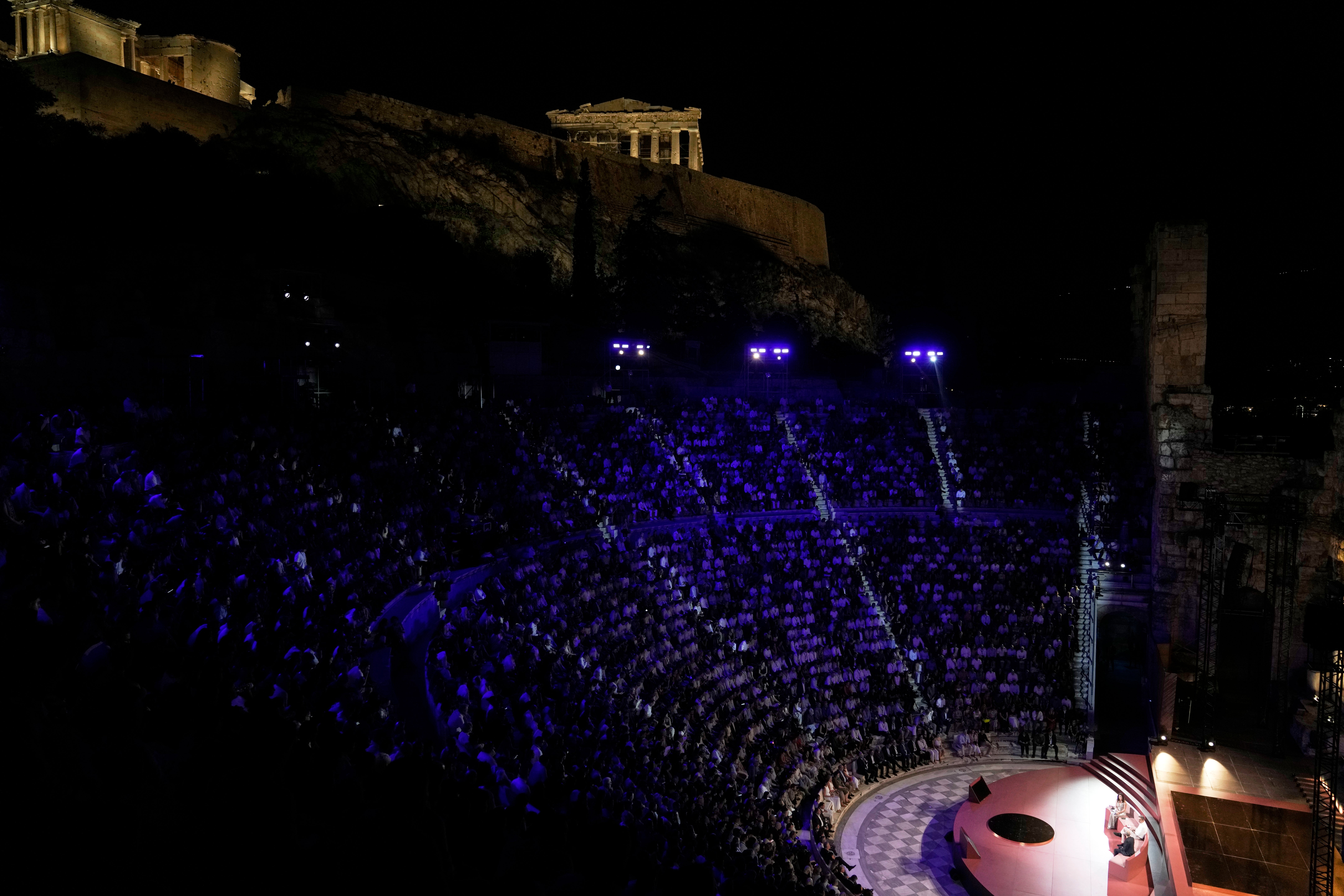 Demis Hassabis, CEO of Google's artificial intelligence research company DeepMind, bottom right, and Greece's Prime Minister Kyriakos Mitsotakis, bottom center, discuss the future of AI, ethics and democracy during an event at the Odeon of Herodes Atticus, under Acropolis ancient hill, in Athens, Greece, Friday, Sept. 12, 2025. (AP Photo/Thanassis Stavrakis)