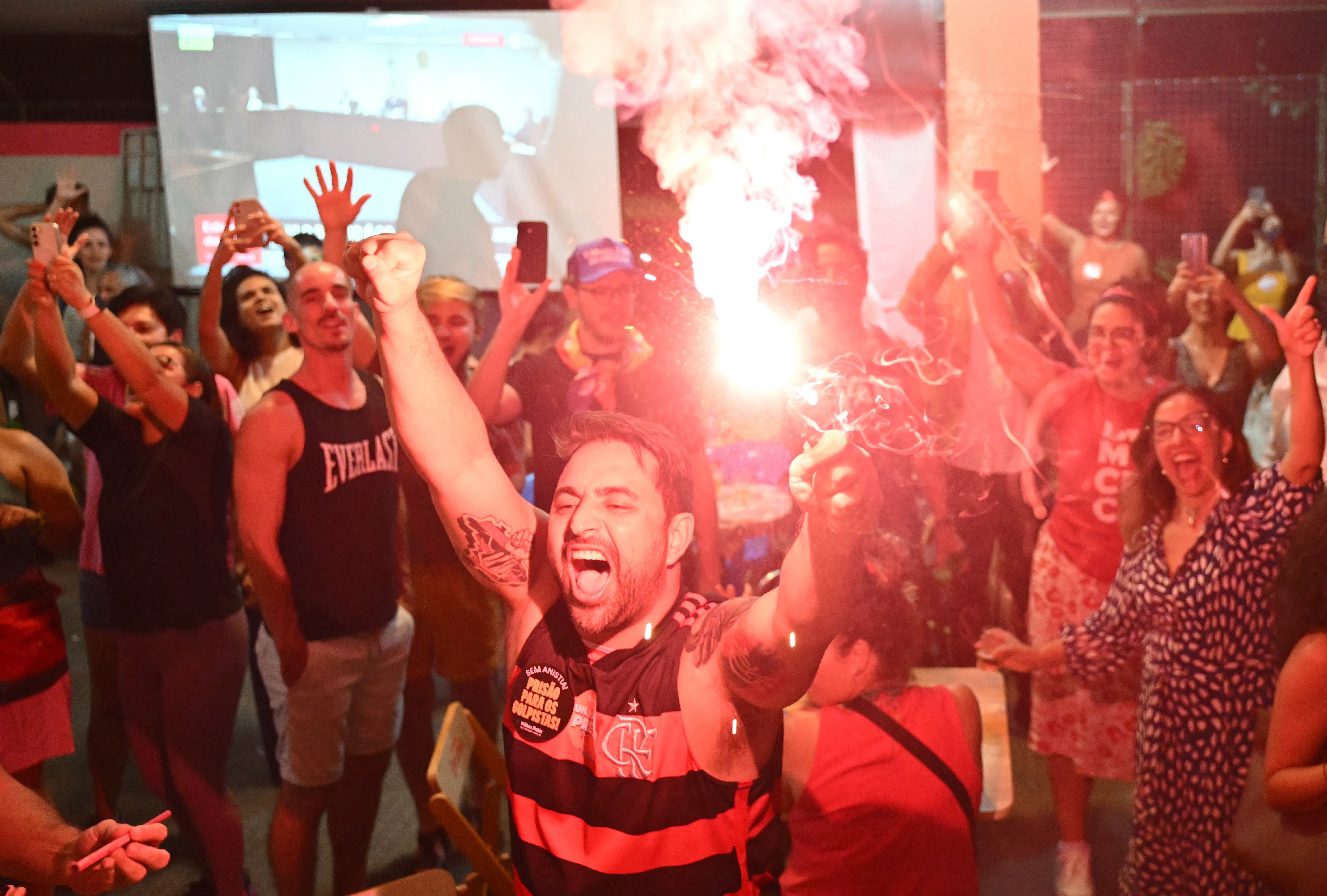People celebrate the Brazil's Supreme Court decision on former President Jair Bolsonaro's trial in Brasilia on September 11, 2025. Brazil's Supreme Court on Thursday convicted firebrand ex-president Jair Bolsonaro of plotting a coup, sealing his fate with a 4-1 vote that could send him to prison for the rest of his life. (Photo by EVARISTO SA / AFP) (Photo by EVARISTO SA/AFP via Getty Images)
