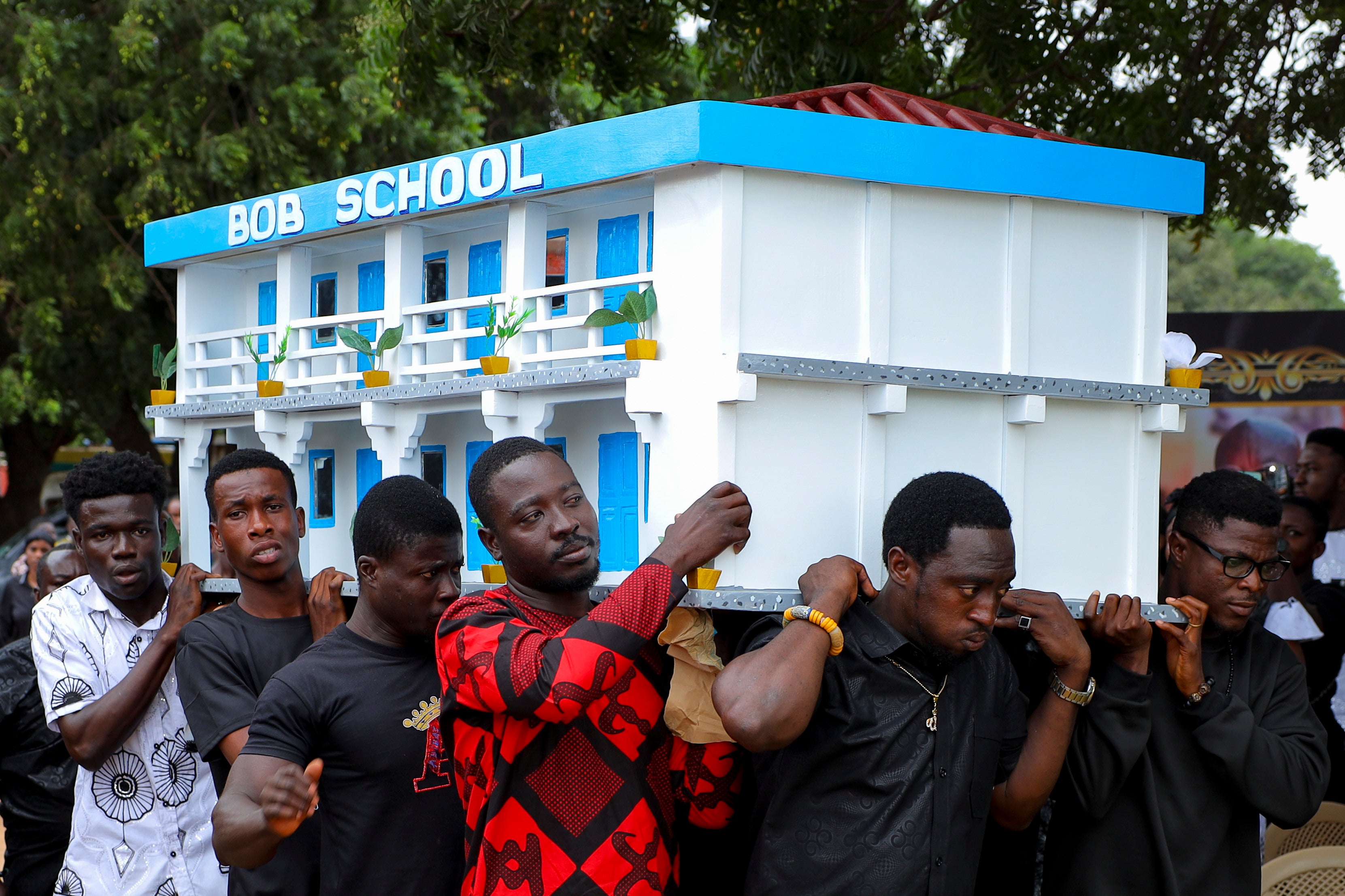 Men carry the fantasy coffin of the late Robert Nii Anang Obodai, a former school proprietor, during his funeral in Accra