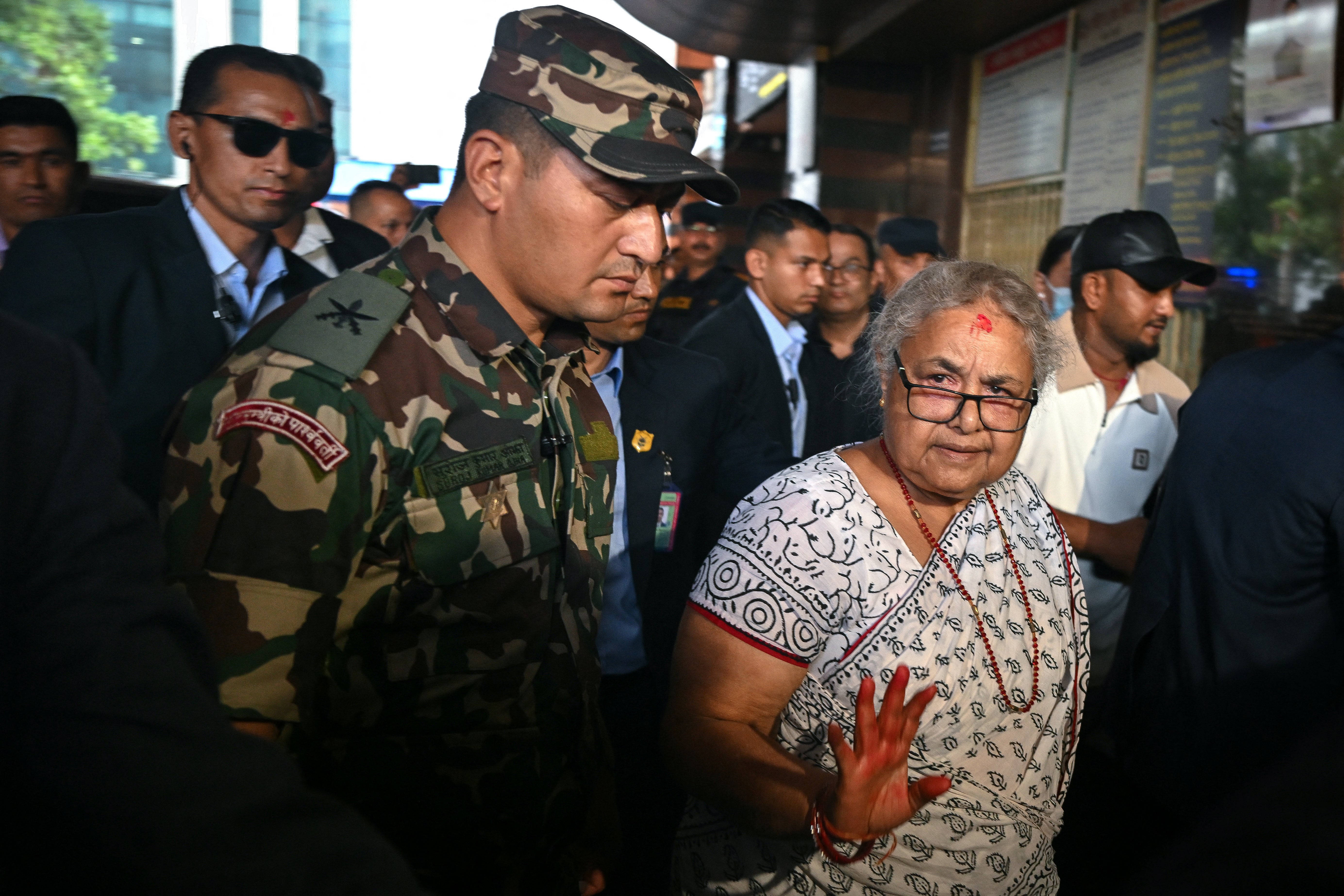 Newly-elected Prime Minister of Nepal's interim government Sushila Karki (front R) arrives at the National Trauma Center hospital to visit victims injured in clashes with security personnel, in Kathmandu on September 13, 2025