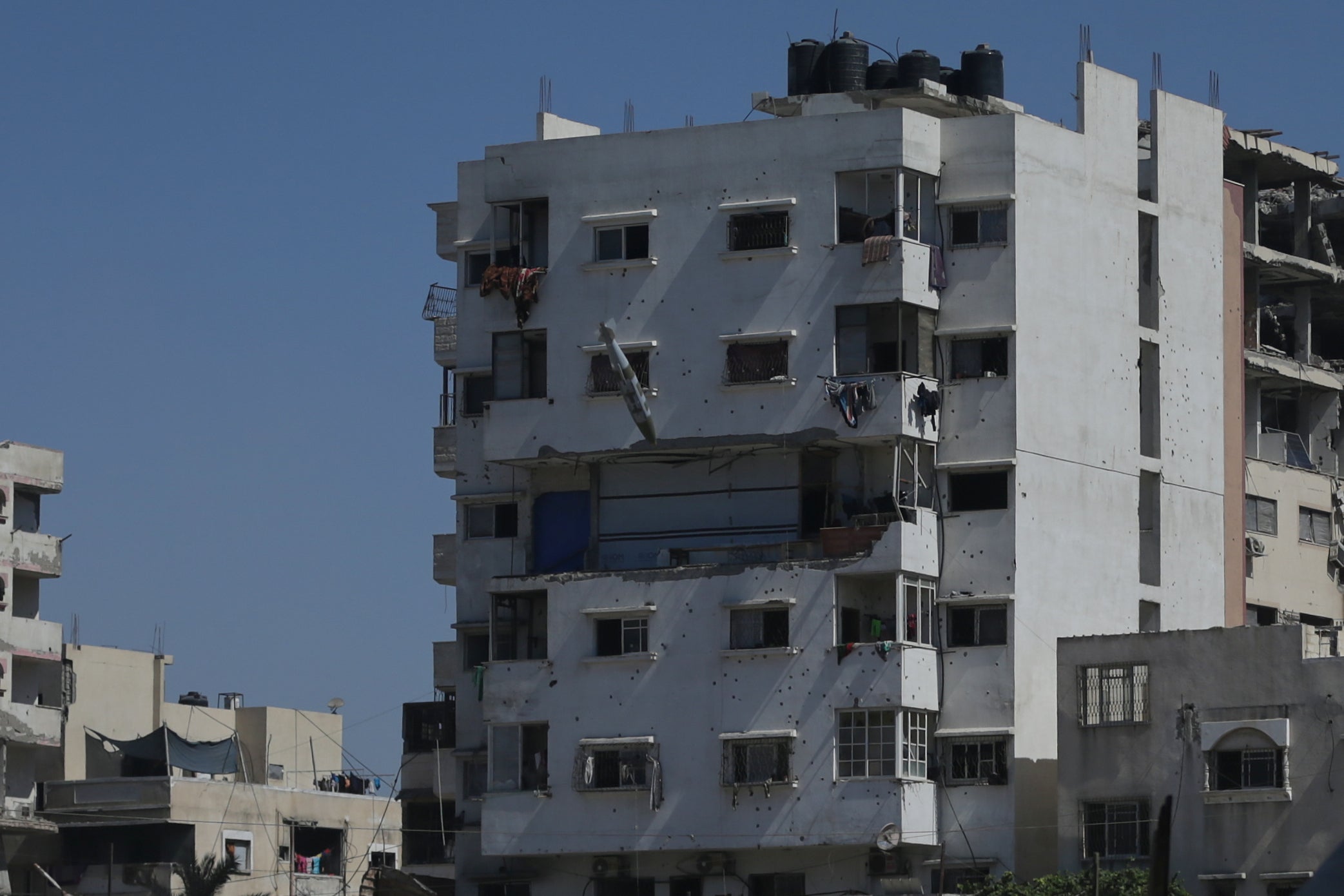 A bomb dropped during an Israeli military strike approaches a building in Gaza City