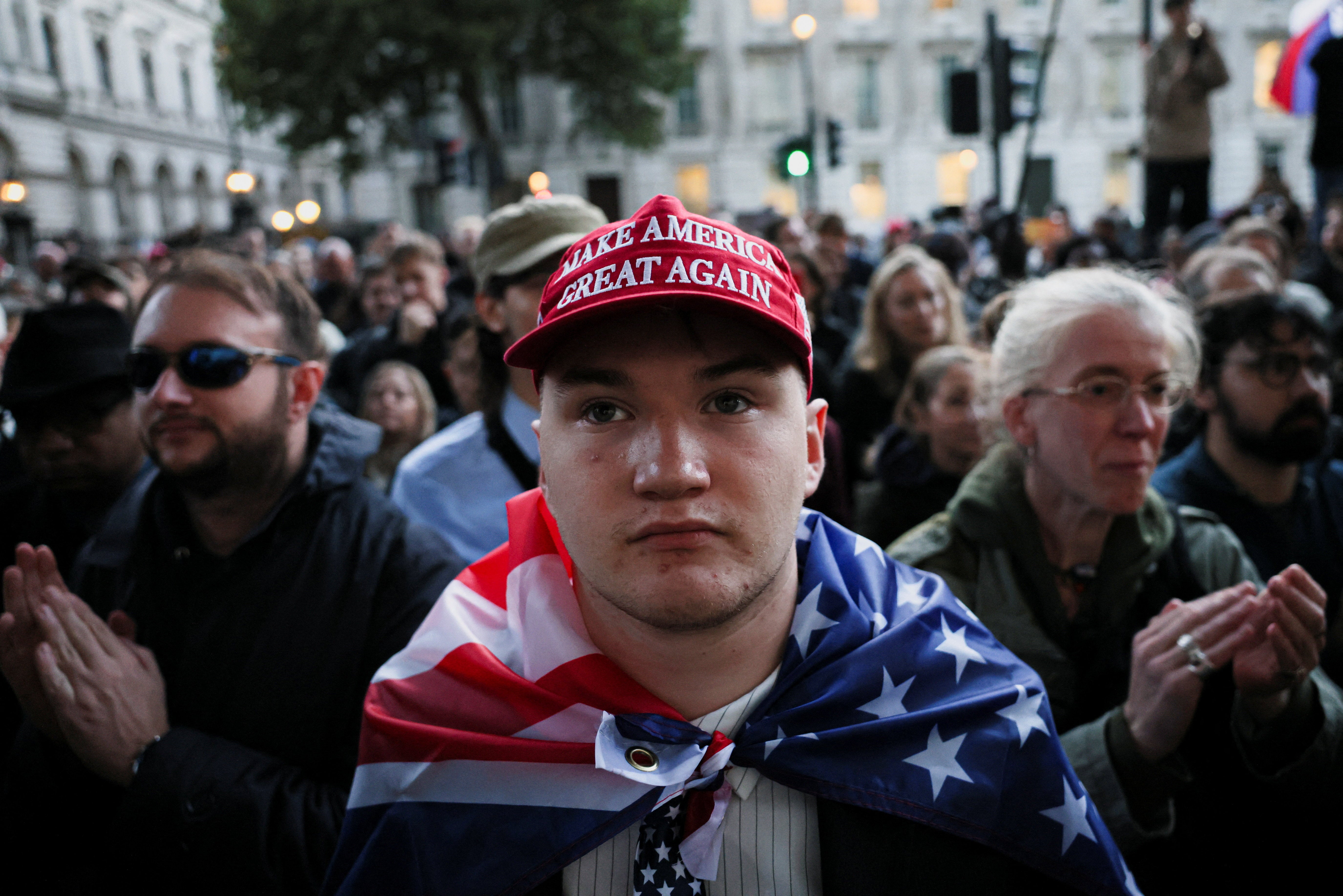 A man wears a MAGA hat as people attend a vigil at the Montgomery Statue in Whitehall, to commemorate U.S. conservative activist Charlie Kirk