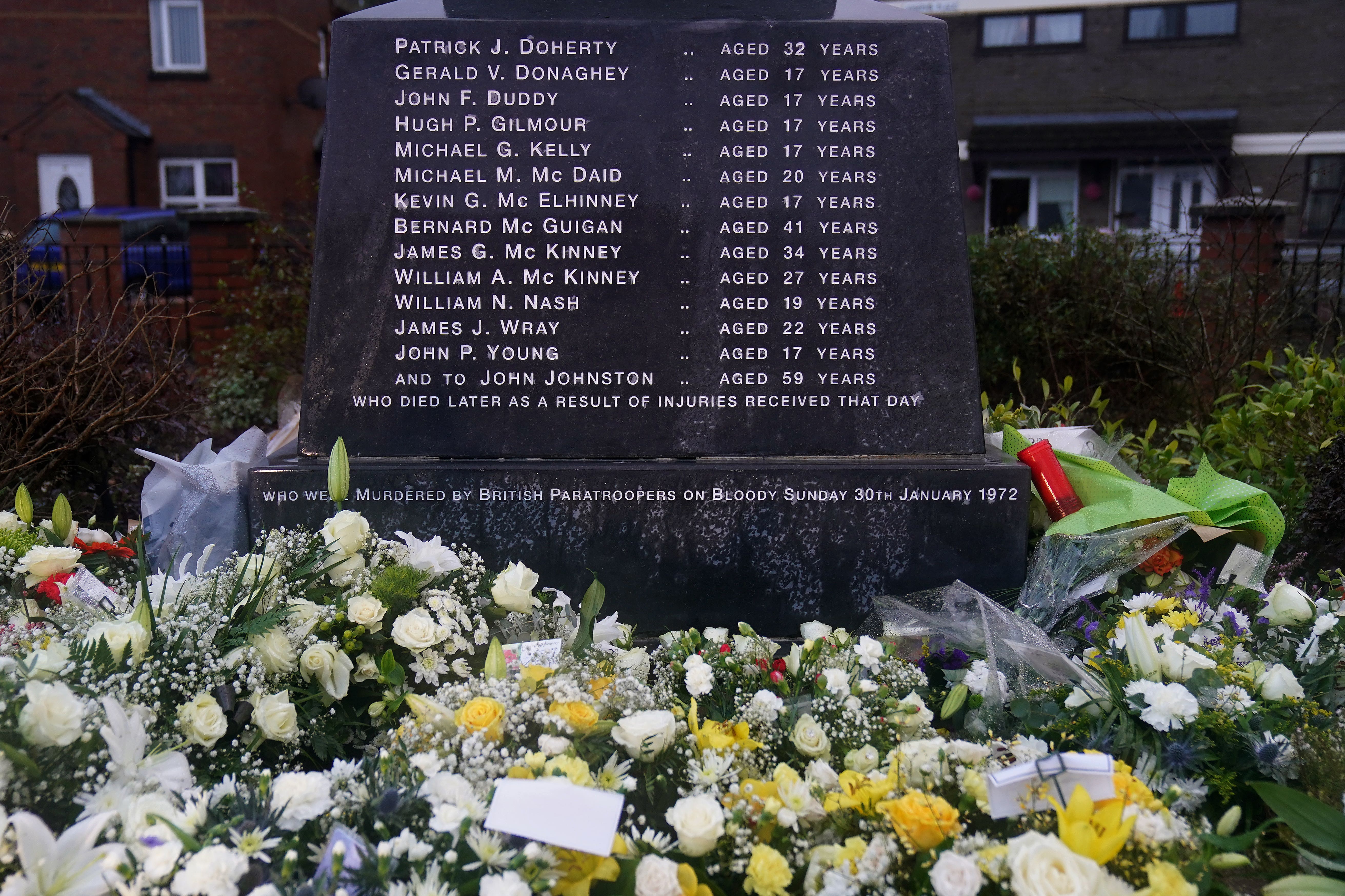 Flowers left at the Bloody Sunday memorial in Derry on the 50th anniversary of Bloody Sunday (PA)