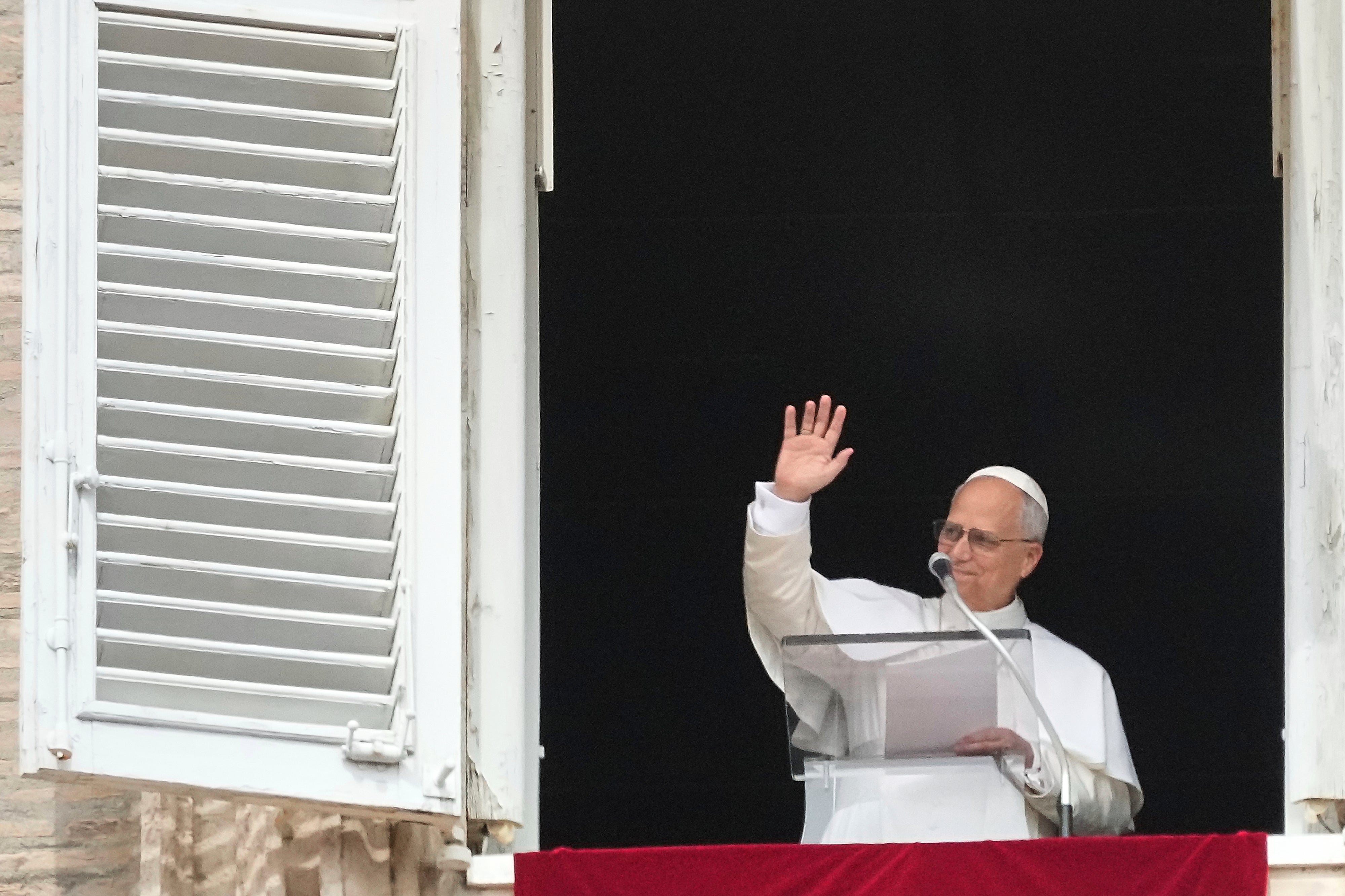 Pope Leo XIV appears at his studio's window to bless the faithful gathered in St. Peter's Square at the Vatican for the Angelus prayer, Sunday, Sept. 14, 2025. (AP Photo/Gregorio Borgia)