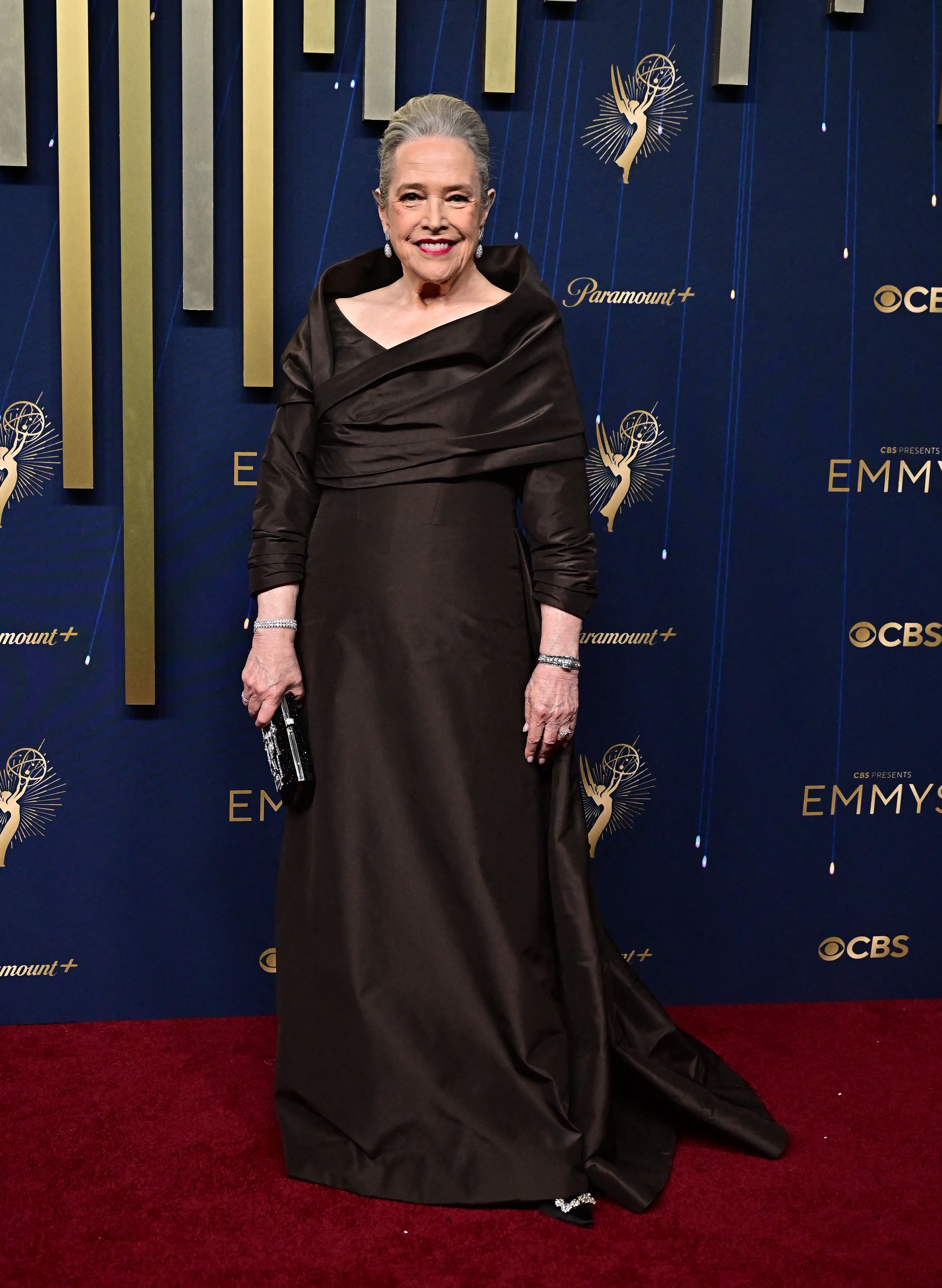 Bates, who is nominated for her role in ‘Matlock,’ stunned in an up-do and red lipstick, but many questioned the 'muddy' color of her dress as well as the fit