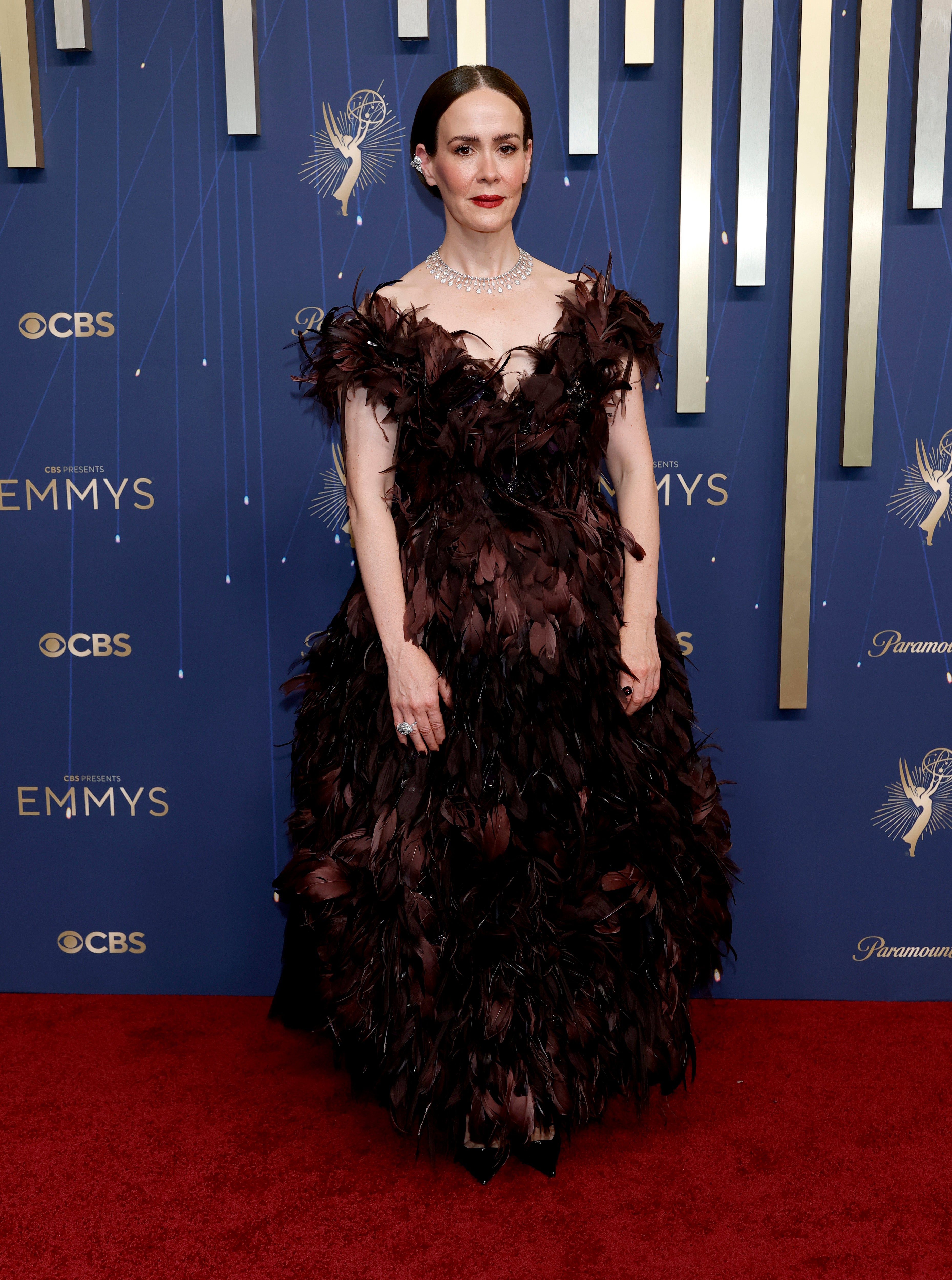 Paulson attempted to play with textures as she wore a brown dress adorned with feathers that made her appear more bird-like rather than elegant