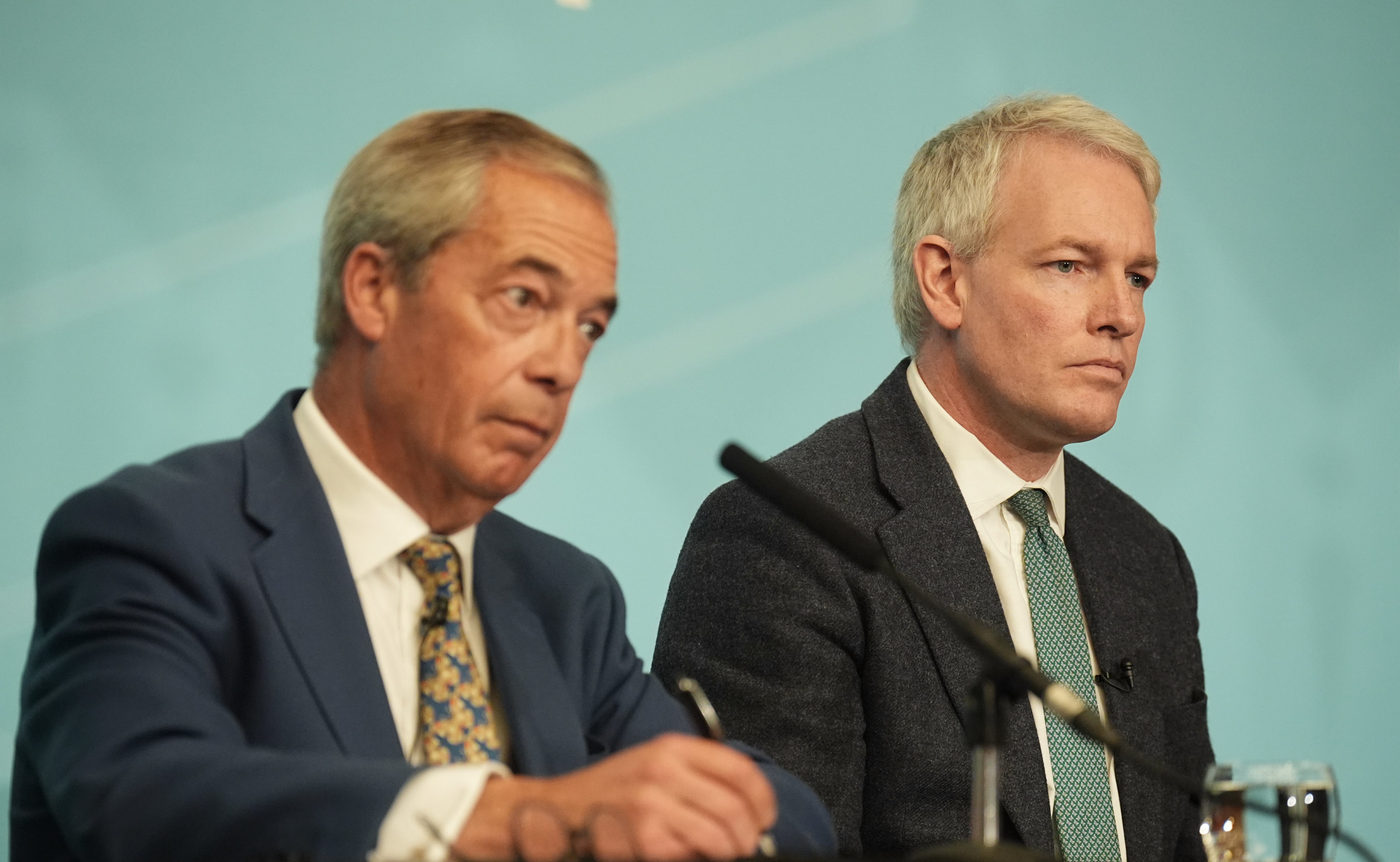 Reform UK leader Nigel Farage with the former Conservative MP during a press conference in Westminster on Monday
