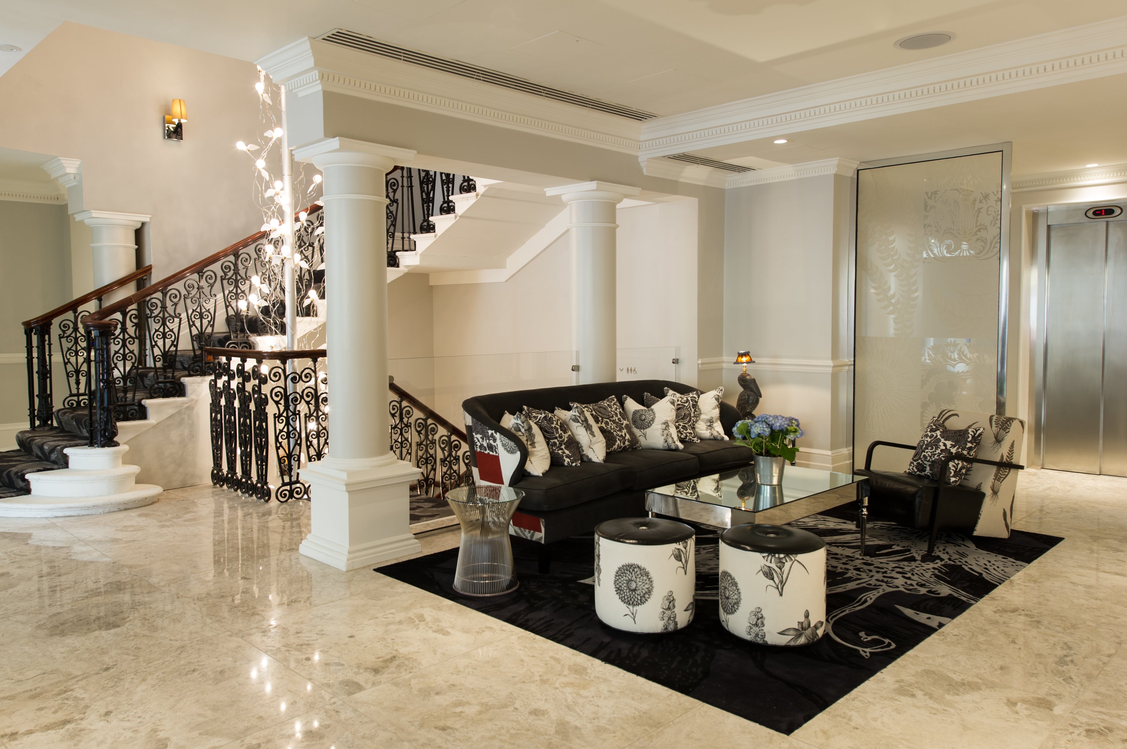 The Ampersand’s wrought-iron staircase is a central feature of the hotel