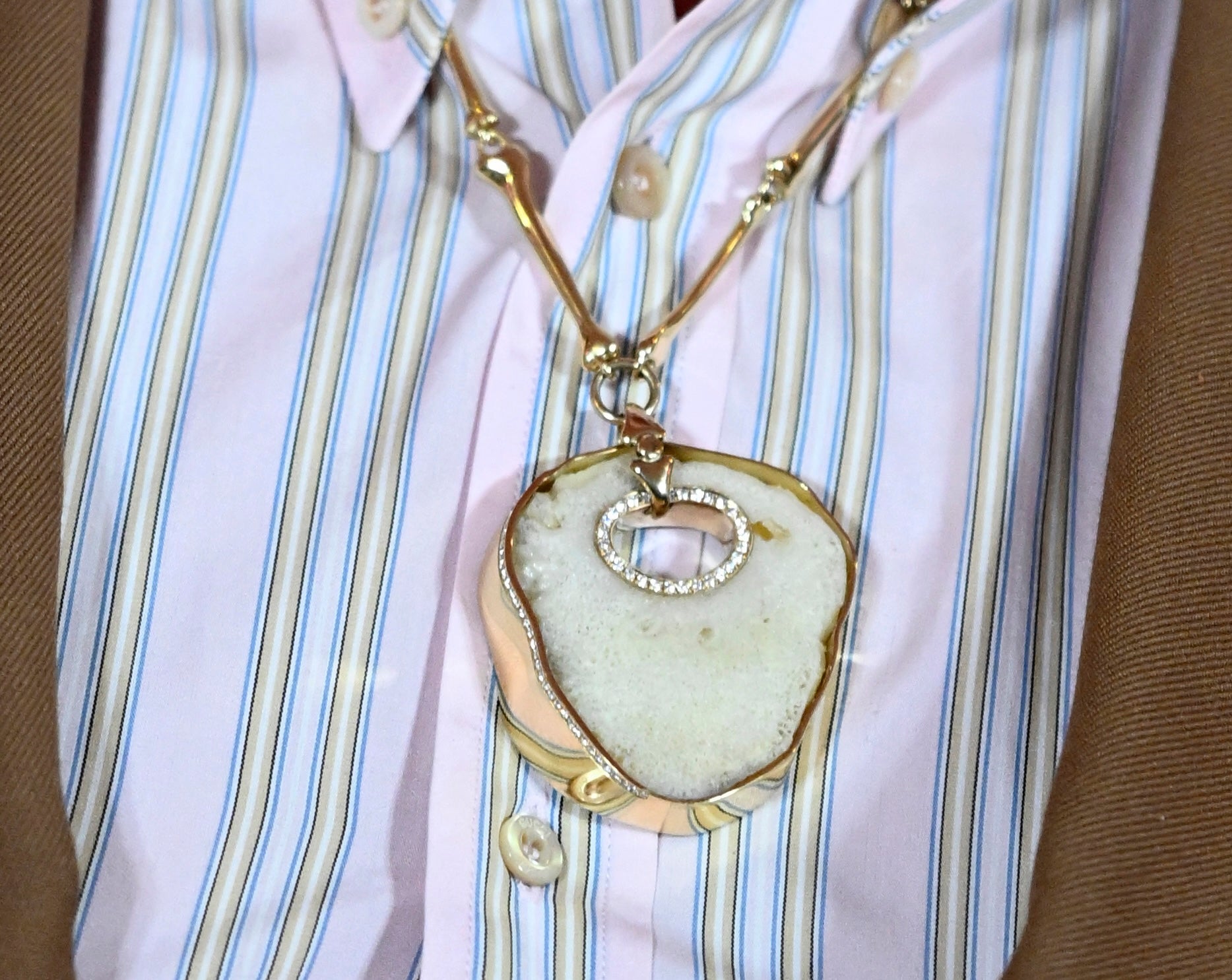 Elton John wearing a necklace made from his own patella