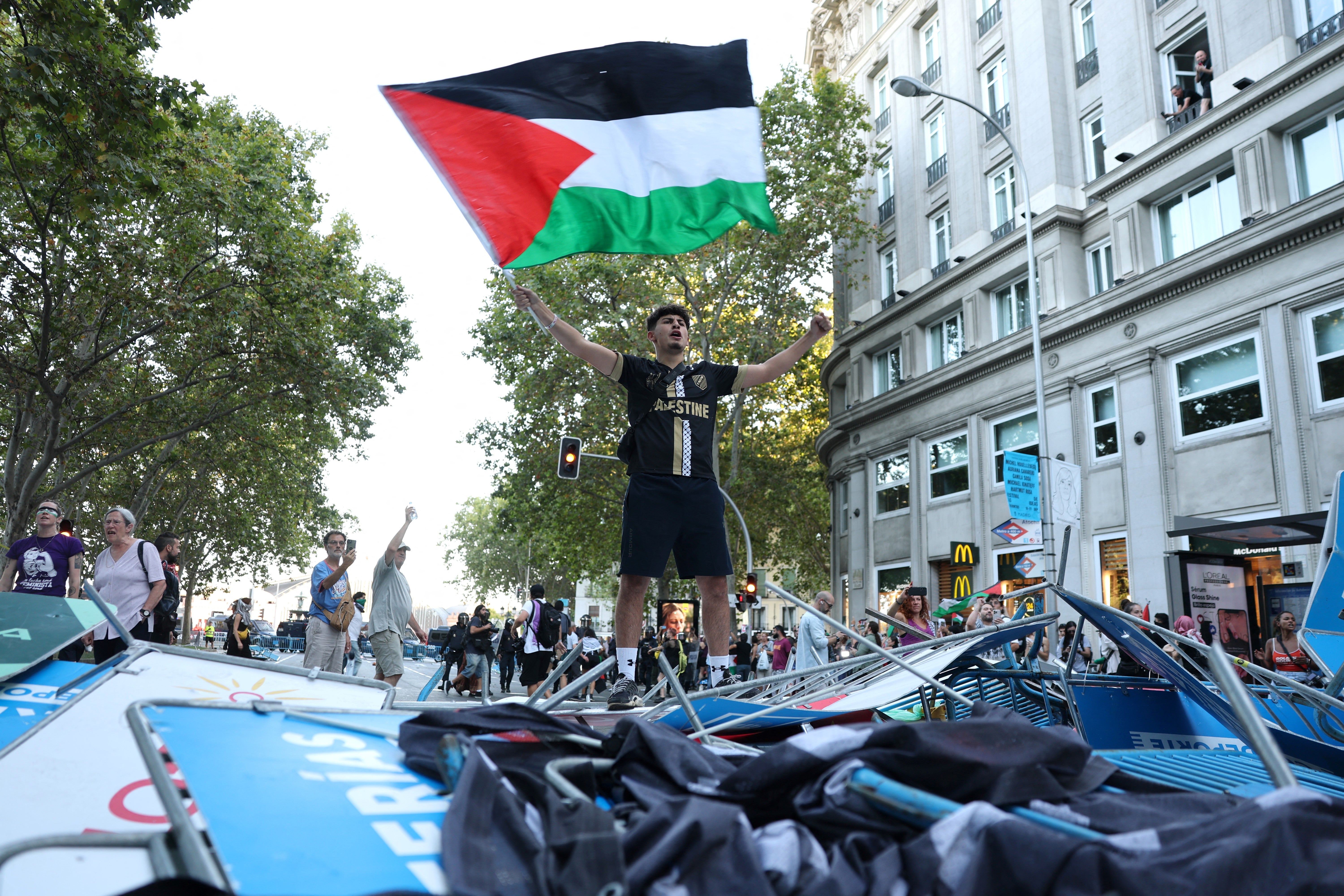 A pro-Palestinians protestor waves a Palestinian flag after the protestors invaded the street during the 21st and last stage of the Vuelta a Espana