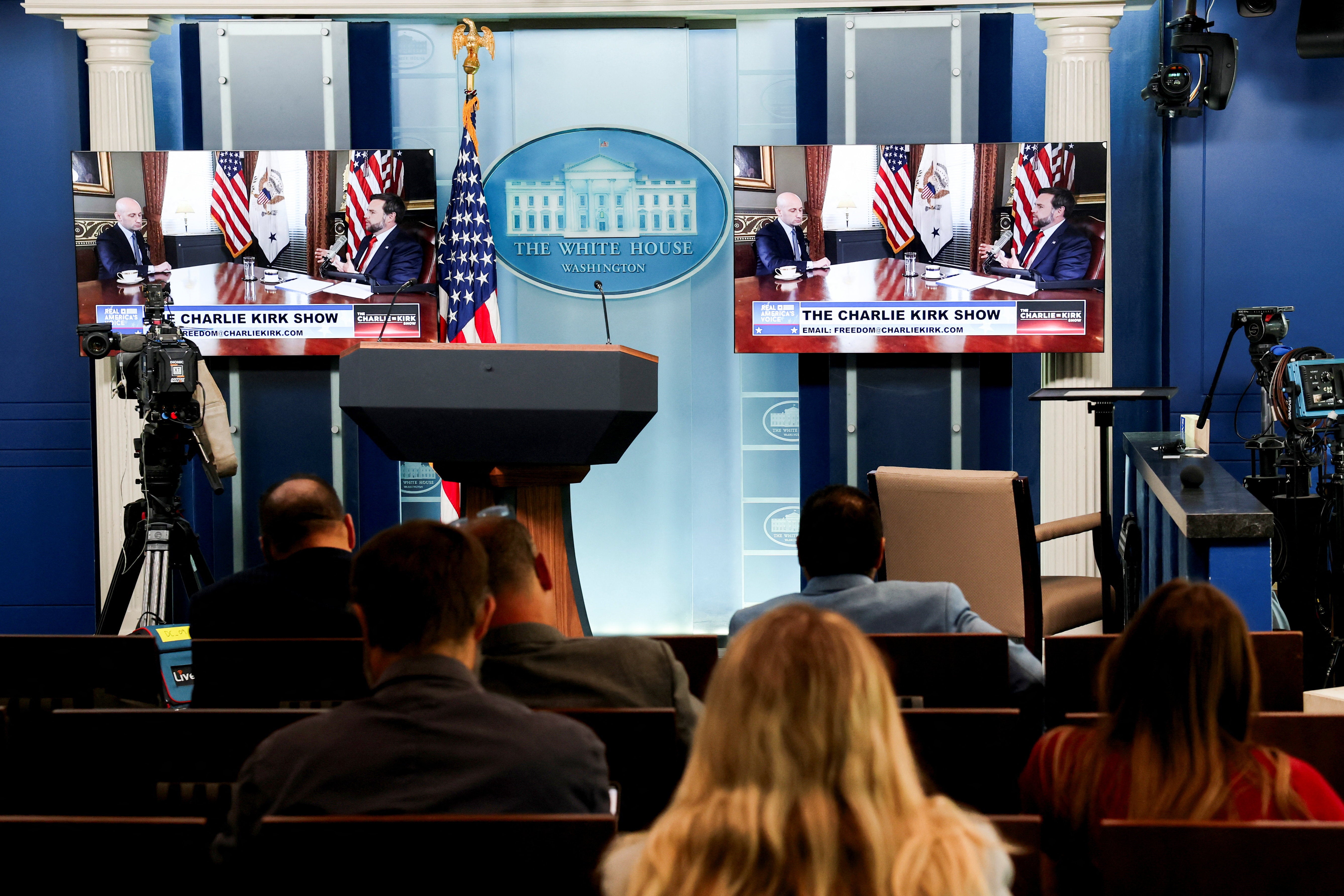 JD Vance and Deputy Chief of Staff Stephen Miller appear on video monitors in the White House press briefing room as guest presenters for the podcast of murdered right-wing influencer Charlie Kirk