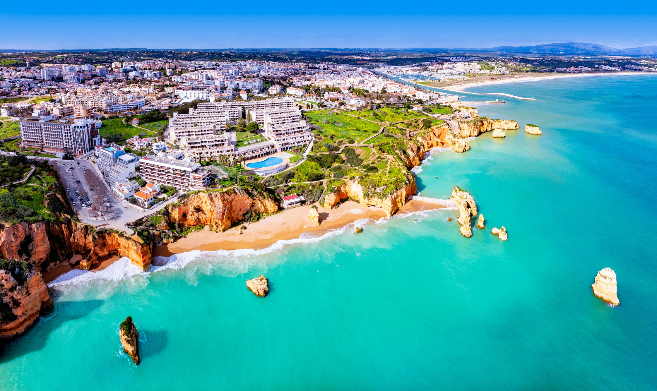 Portugal is the No.1 migration choice for Americans looking to live abroad. Pictured: the Praia Dona Ana beach in the Algarve, Portugal, which is a top spot to lounge in the sand.