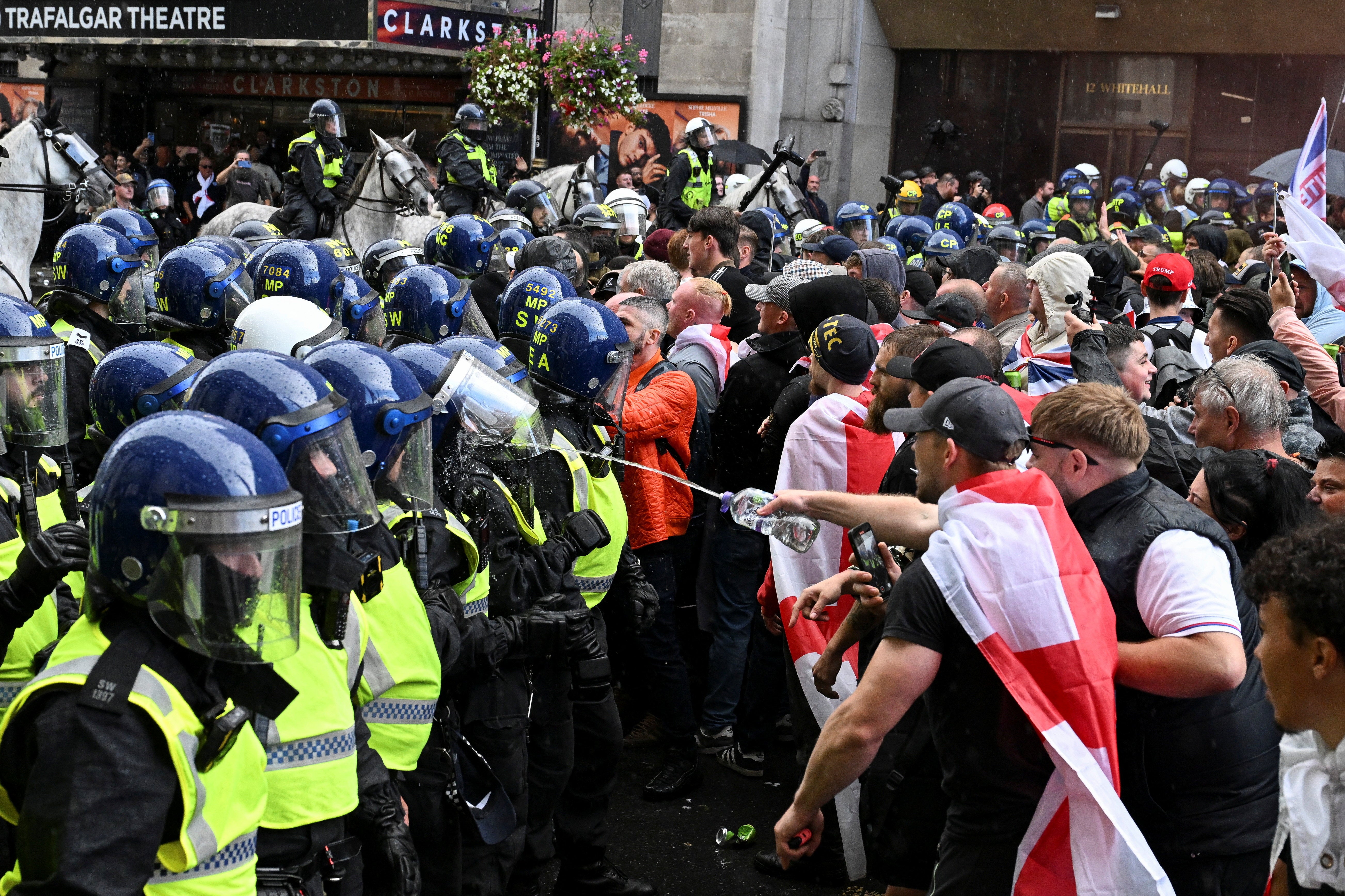Police officers confront supporters of Tommy Robinson during Saturday’s rally