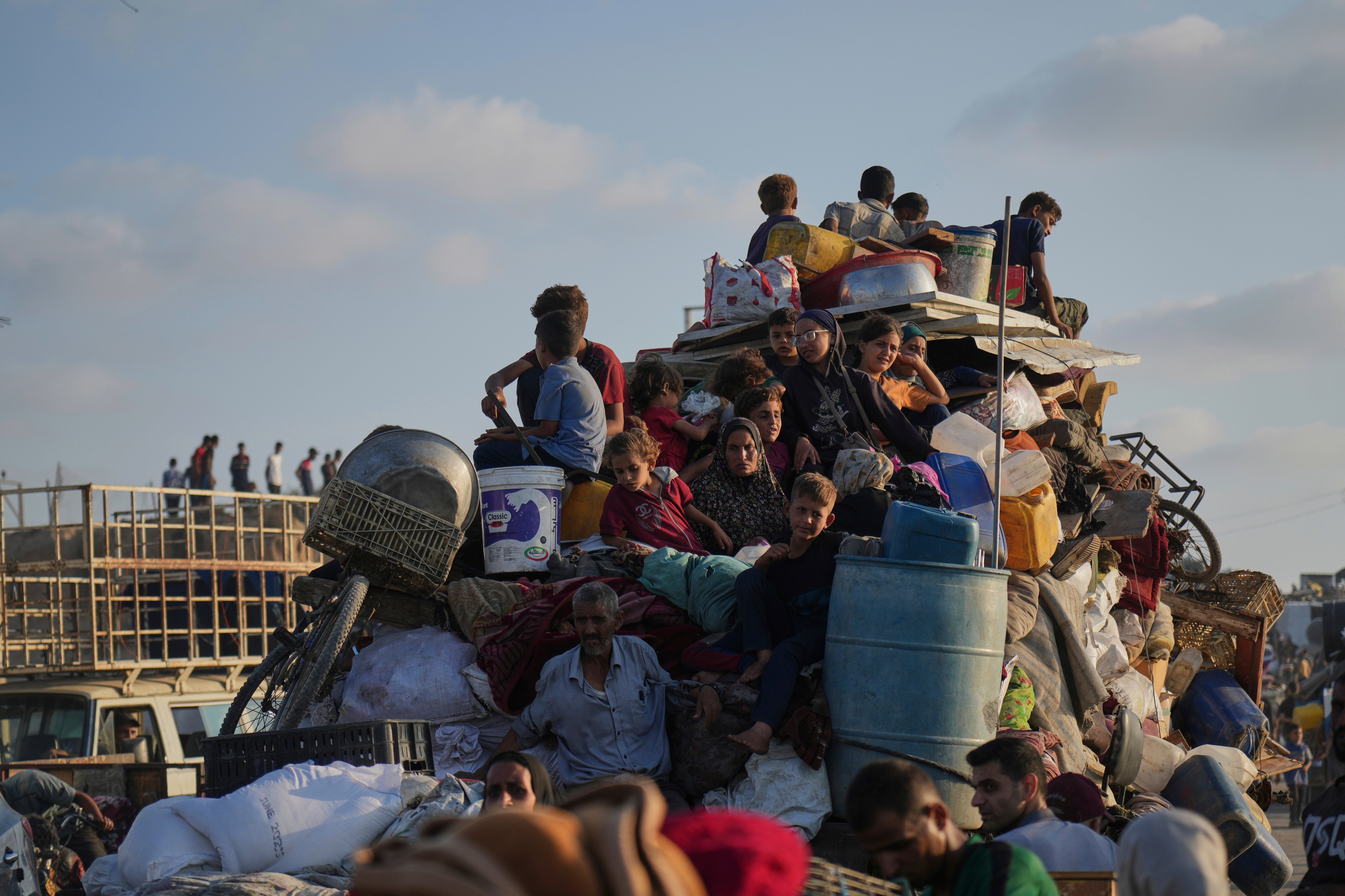 Displaced Palestinians flee northern Gaza by foot and in vehicles, carrying their belongings along the coastal road toward southern Gaza, Monday, Sept. 15, 2025. (AP Photo/Abdel Kareem Hana)
