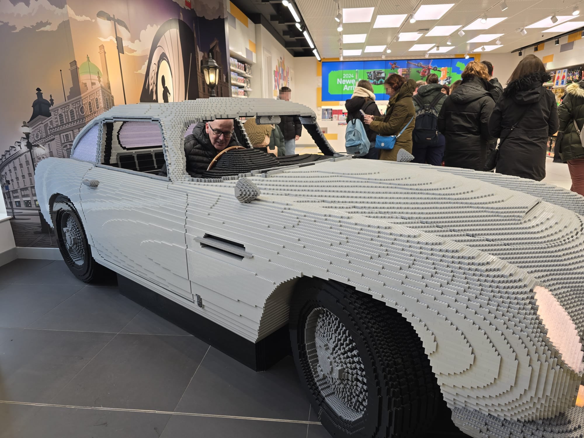 William sitting inside a full-sized replica of James Bond’s Aston Martin in the Lego Store in London