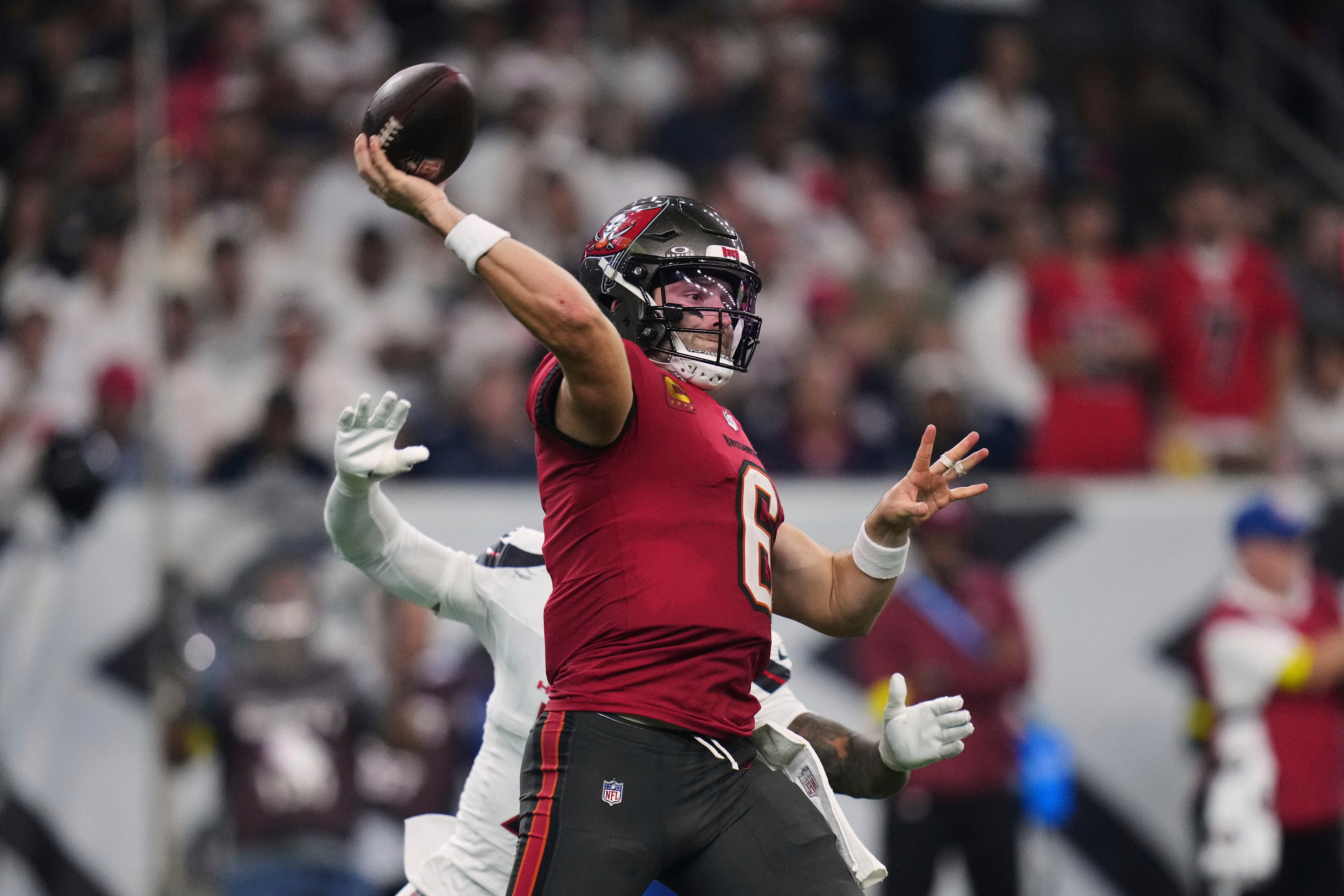 Tampa Bay Buccaneers quarterback Baker Mayfield (6) throws a pass under pressure from Houston Texans safety Jalen Pitre (Eric Gay/AP)