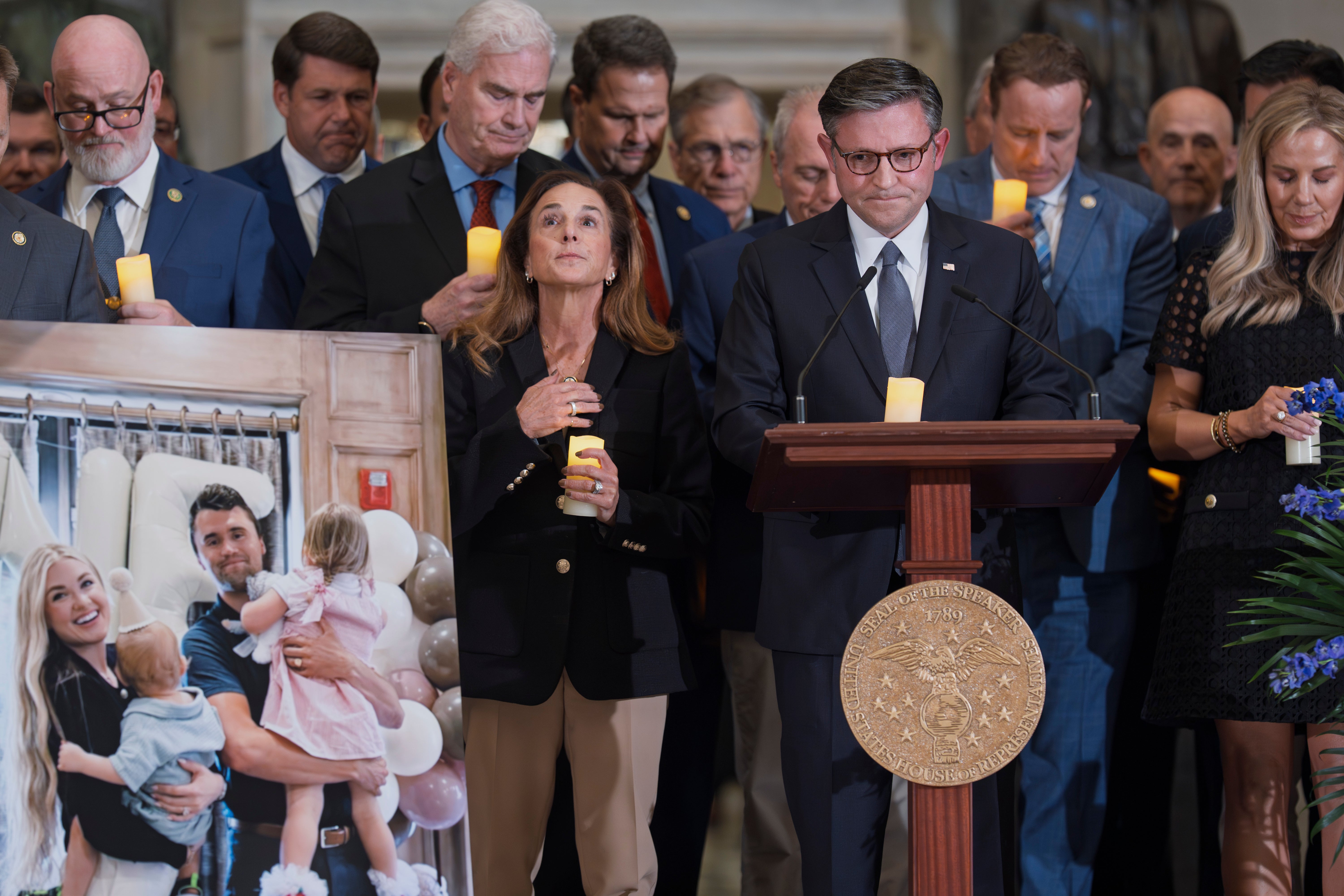 Speaker of the House Mike Johnson, R-La., joined at left by Rep. Lisa McClain, R-Mich., leads a memorial vigil to honor Kirk on Sept. 15