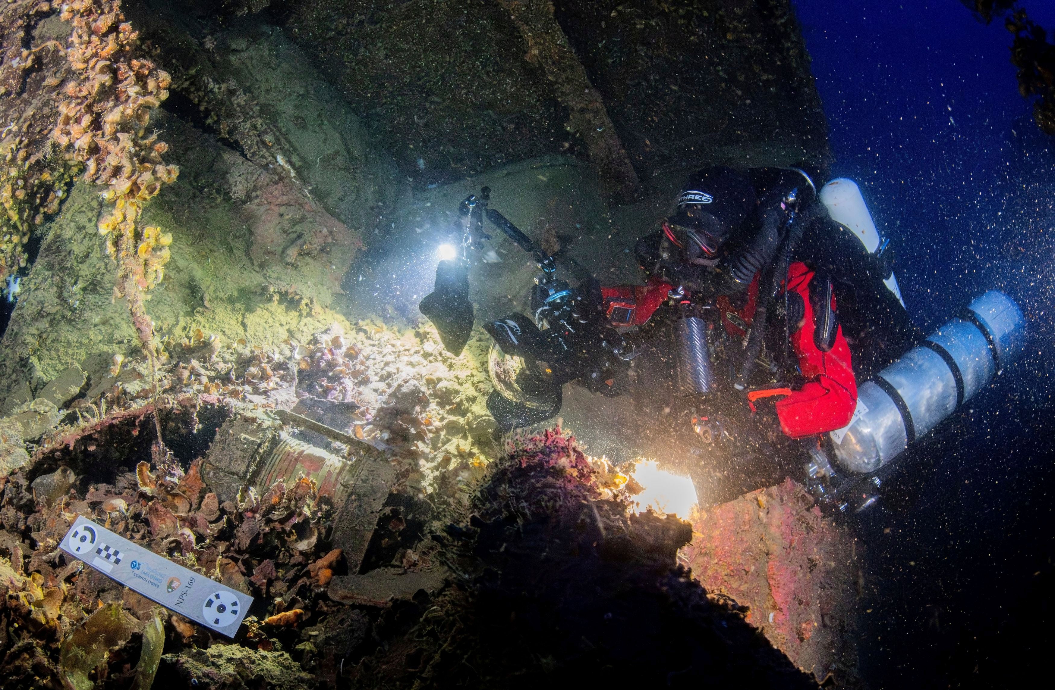In this undated photo provided by the Greek Culture Ministry on Monday, Sept. 15, 2025, divers illuminate the wreck's interior of the Britannic, sister ship to the Titanic, for the first time since the ocean liner sank in the Aegean Sea more than a century ago after striking a mine during World War I. (Greek Culture Ministry via AP)