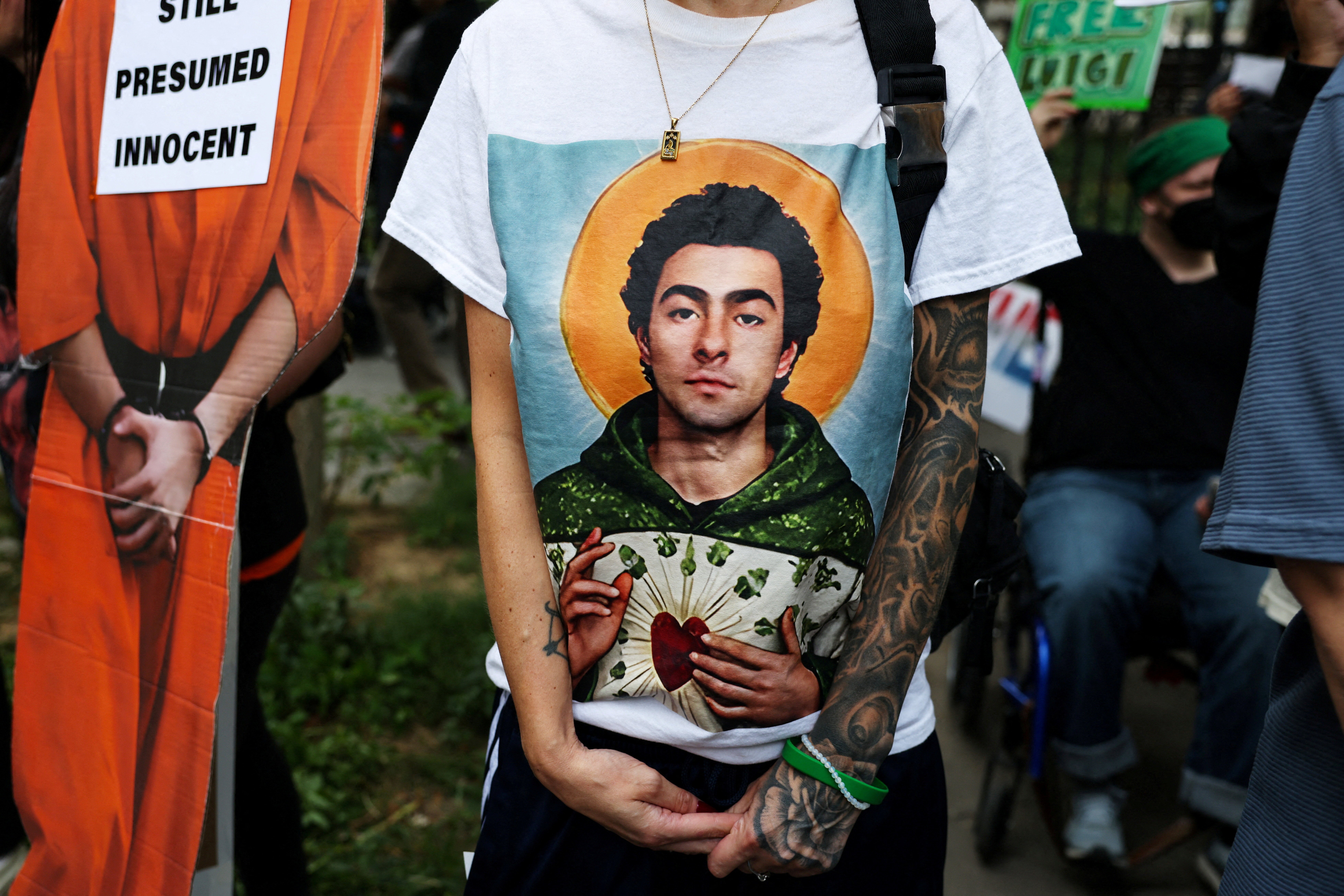 One supporter showed up at the Manhattan Criminal Court wearing a t-shirt bearing Mangione’s face, depicted as an angelic figure