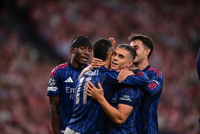 <p>Arsenal’s Gabriel Martinelli, second left, celebrates with Leandro Trossard</p>