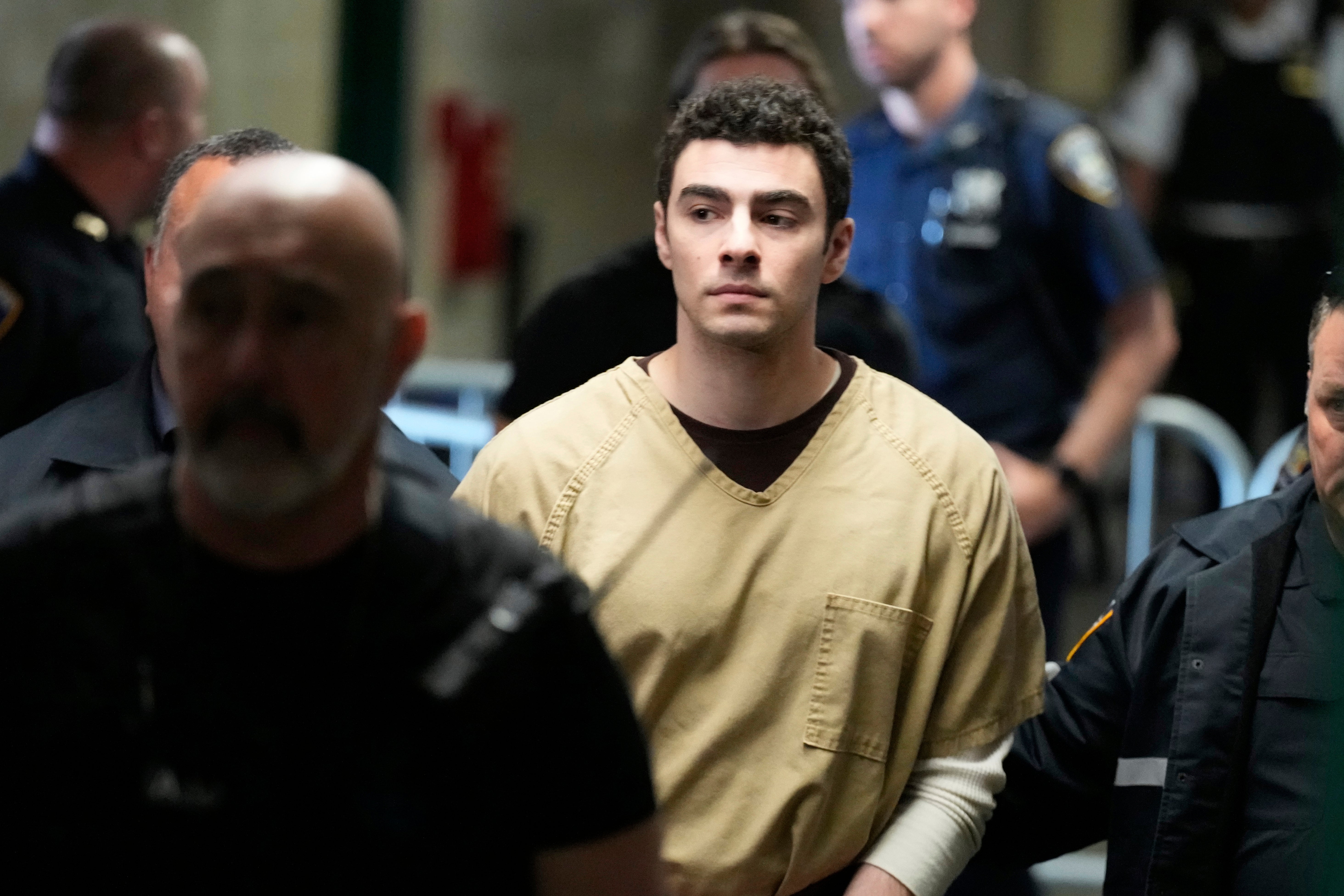 Luigi Mangione is escorted into a New York state court