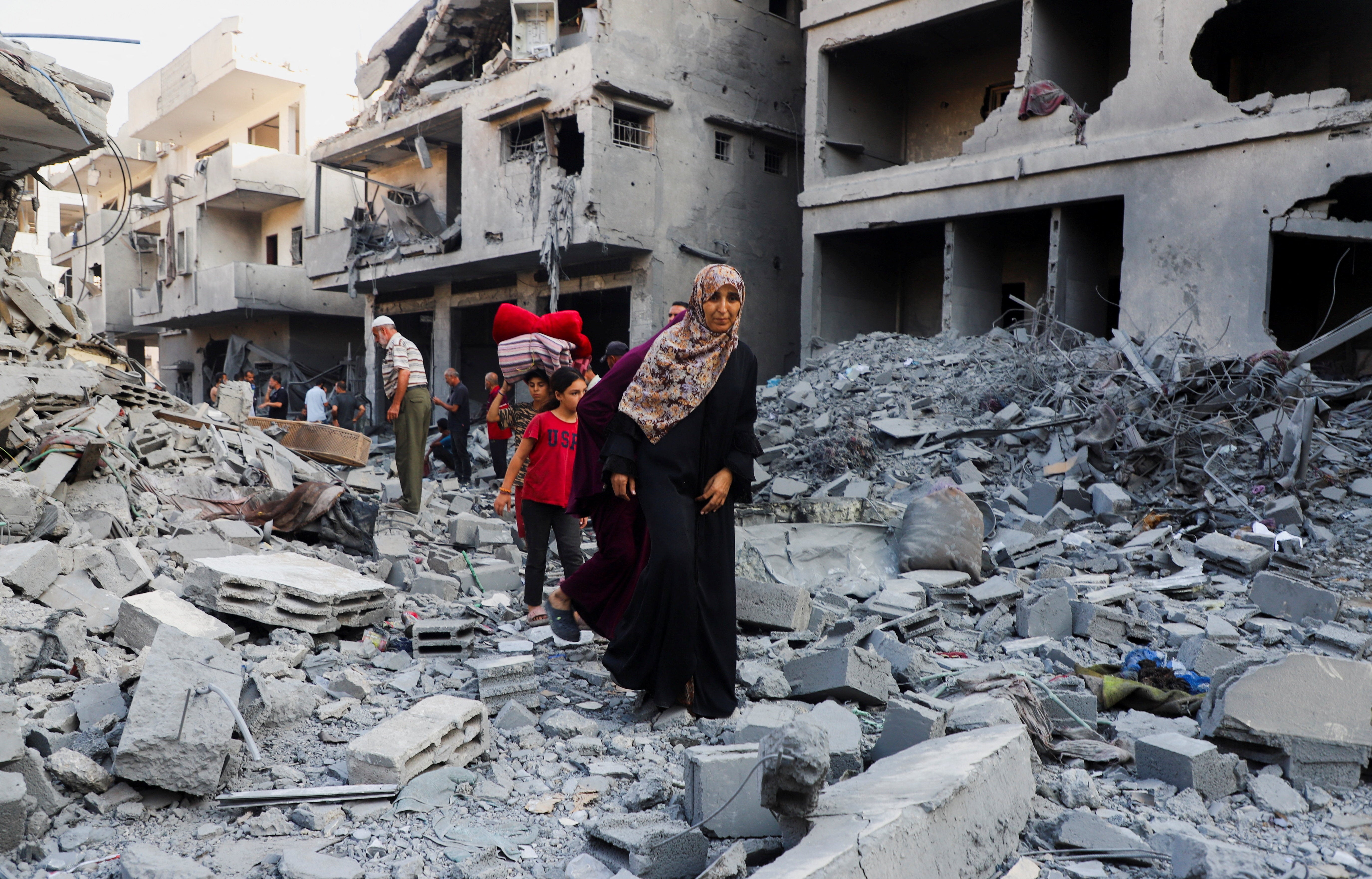 Palestinians inspect the site of an overnight Israeli strike in Gaza City
