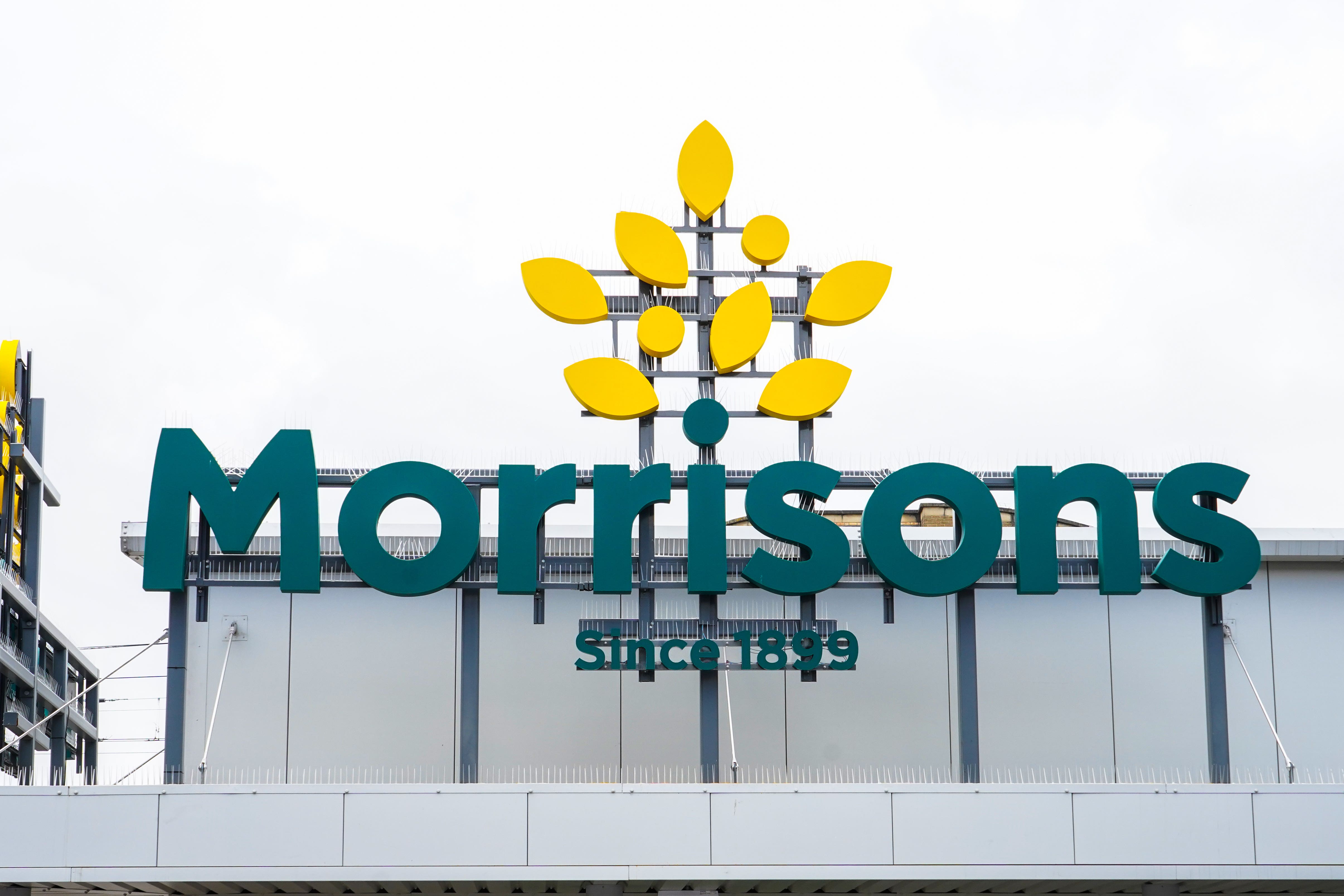Morrisons has posted slowing sales in the latest quarter as customers feel ‘the squeeze’ (Ian West/PA)