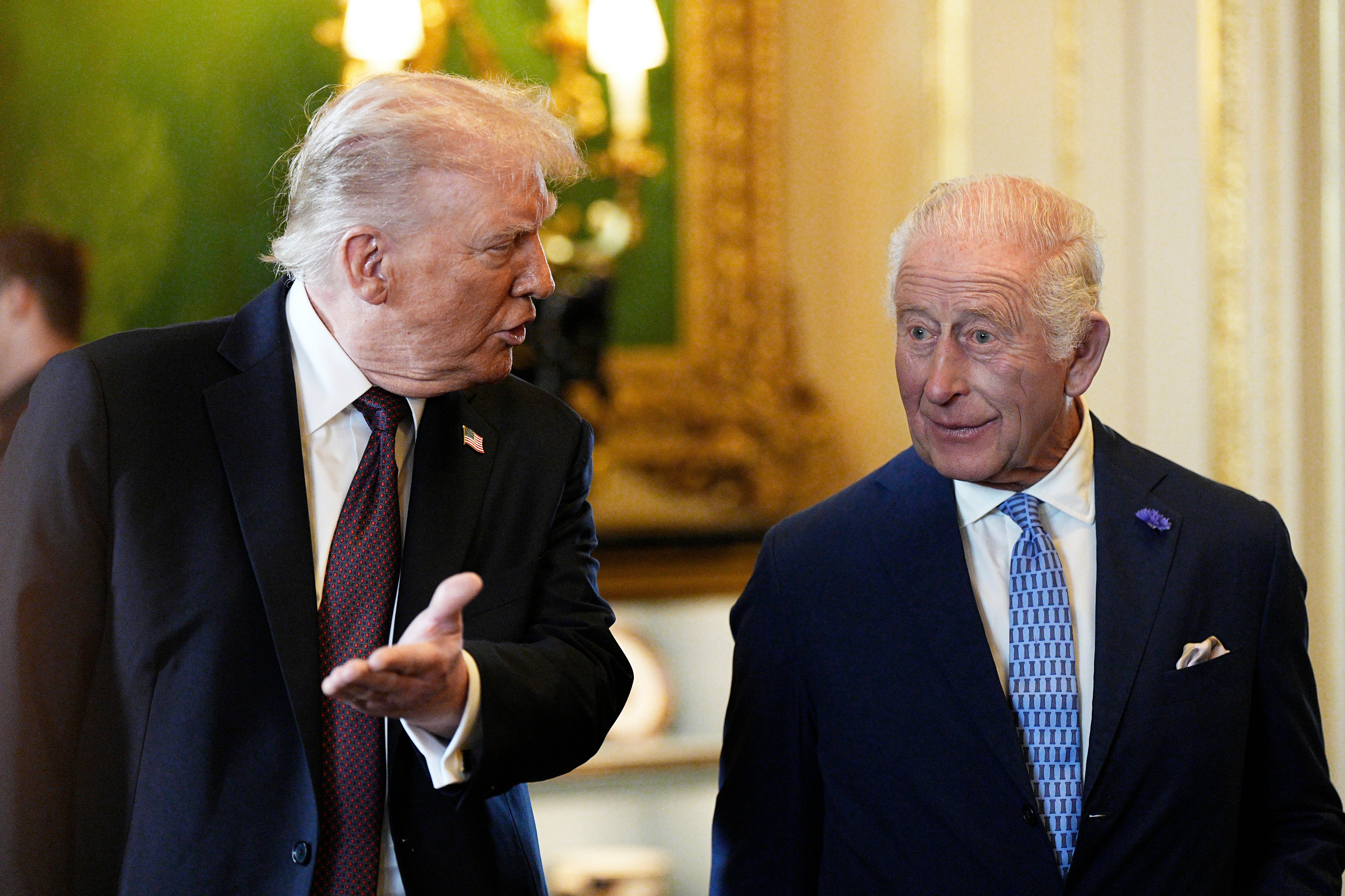 US President Donald Trump (left) and King Charles III view items on display during a visit to the Royal Collection exhibition in the Green Drawing Room at Windsor Castle
