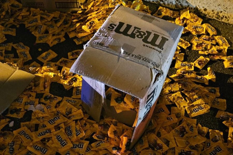 The westbound tractor-trailer was carrying a full load of Peanut M&M's, which spilled onto the road in boxes and bags following the collision