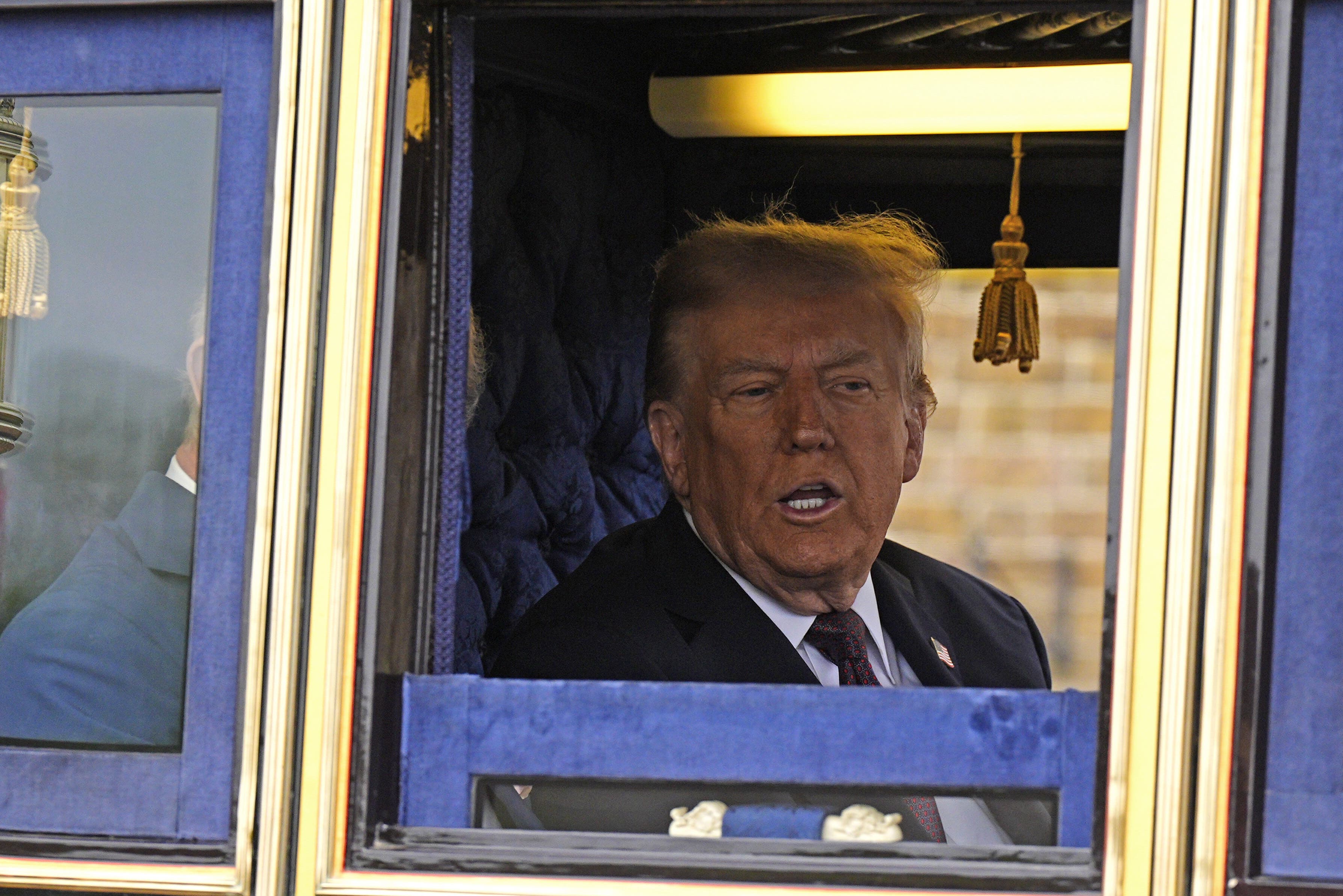 Trump is taken for a drive around Windsor Park in a golden carriage with the King