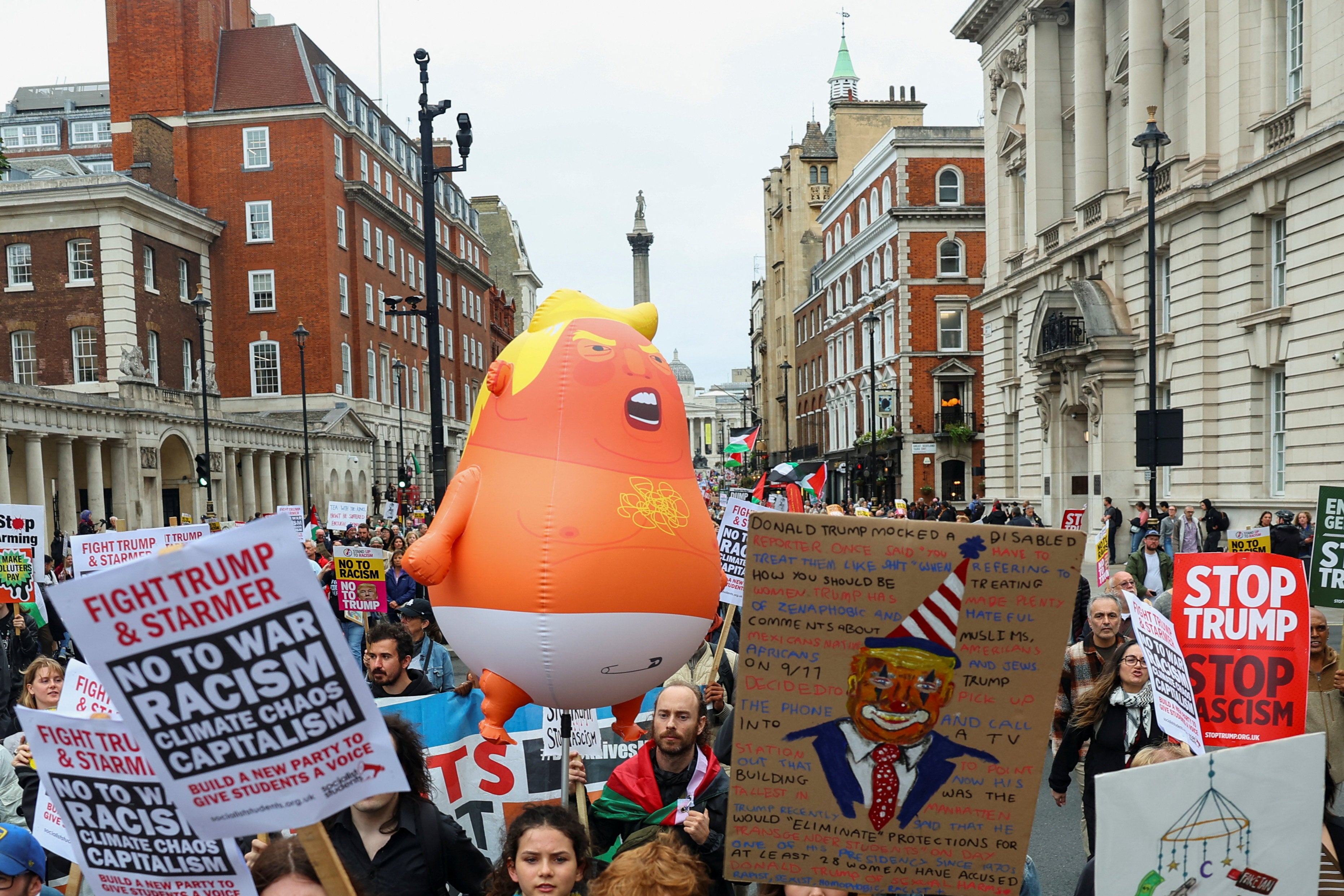 A balloon depicting U.S. President Donald Trump is held at a 'Trump Not Welcome' protest during the state visit of U.S. President Donald Trump and first lady Melania Trump, as Nelson's Column stands in the background, in London, Britain, September 17, 2025. REUTERS/Isabel Infantes