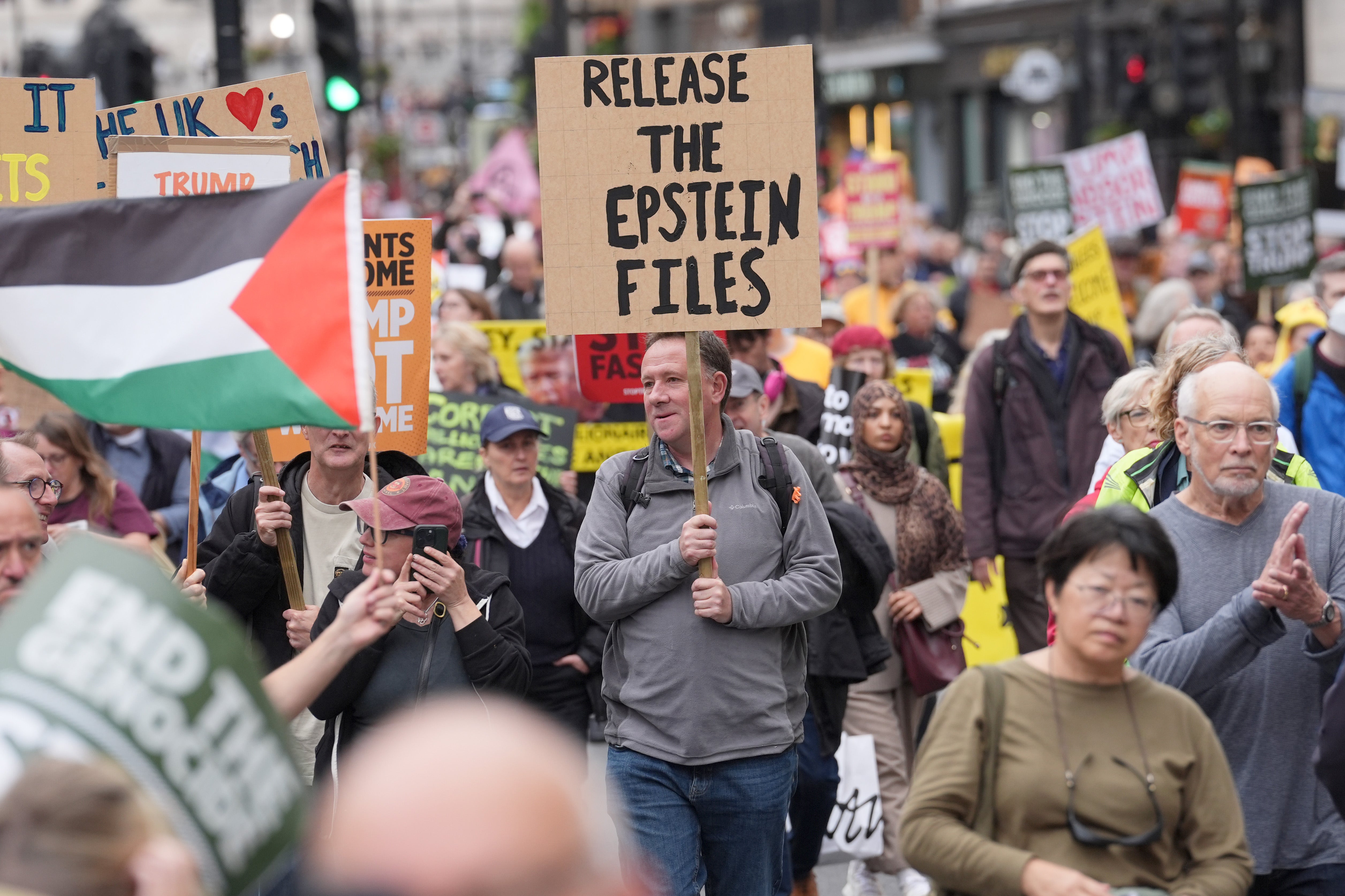 Stop Trump Coalition campaigners take part in a protest march in London on Wednesday