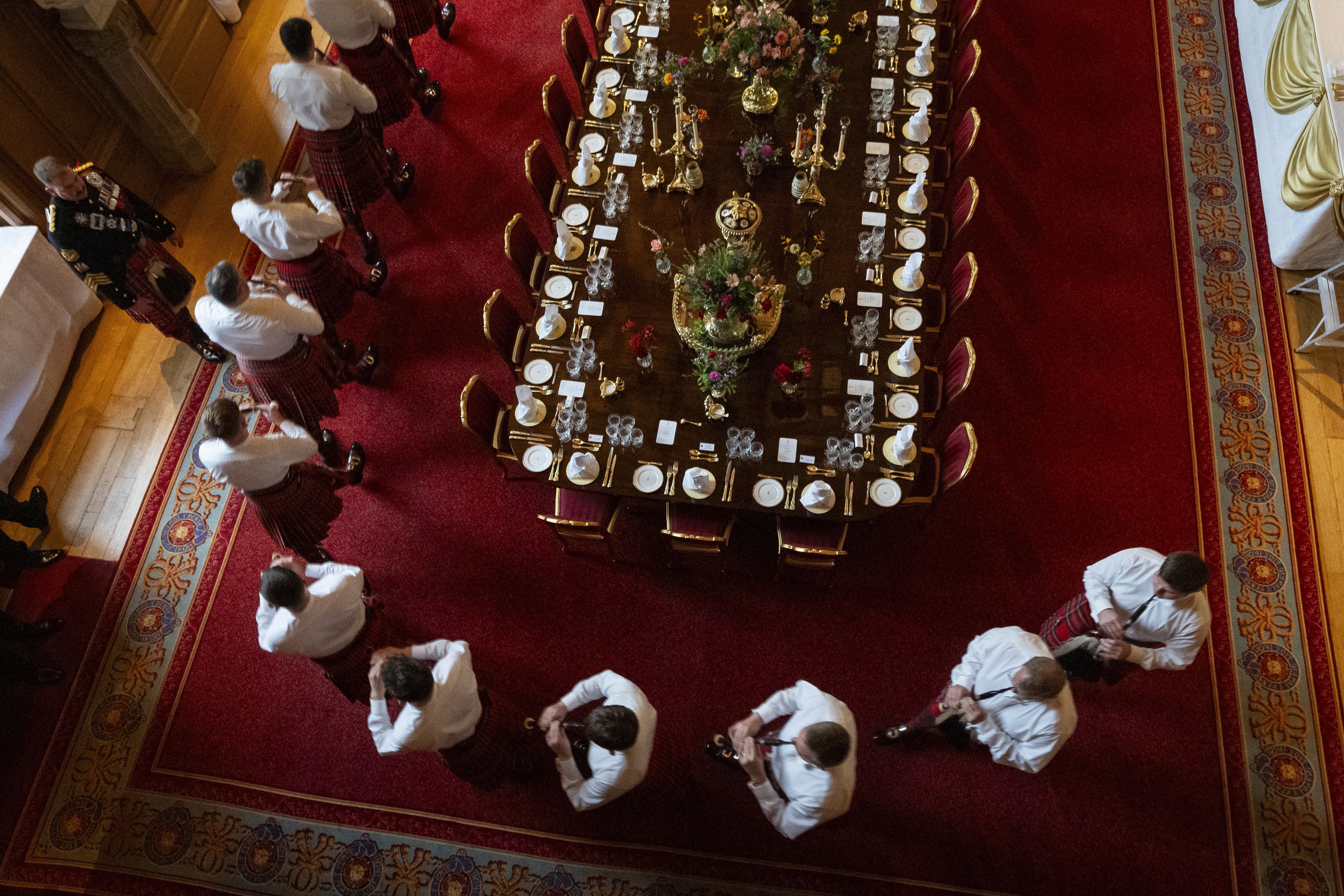Pipers rehearse next to the banquet table (Aaron Chown/PA)