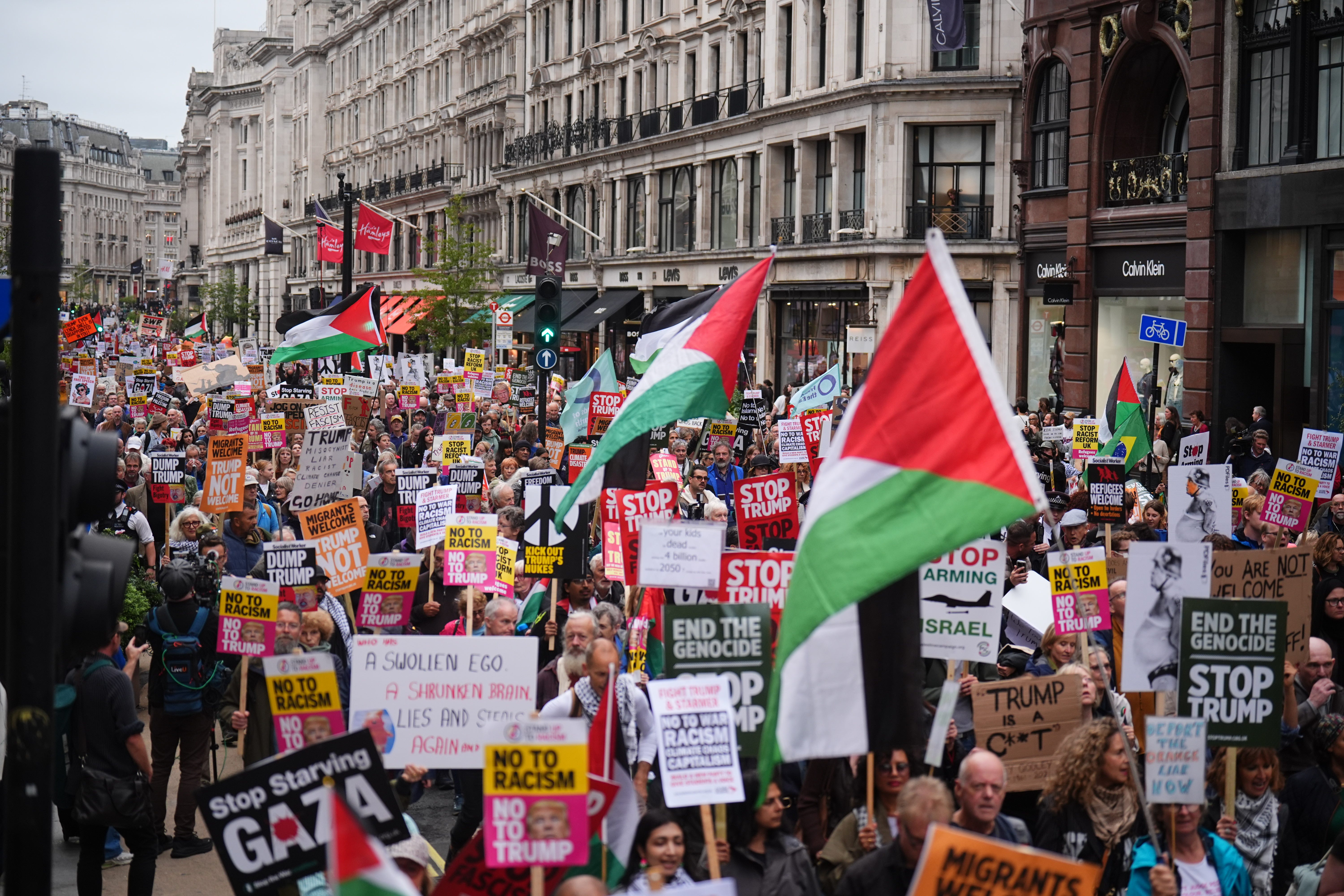 Campaigners hold signs and wave Palestinian flags during a Stop Trump Coalition protest march from Portland Place to Parliament Square in London, on day one of the US president’s second state visit to the UK (James Manning/PA)
