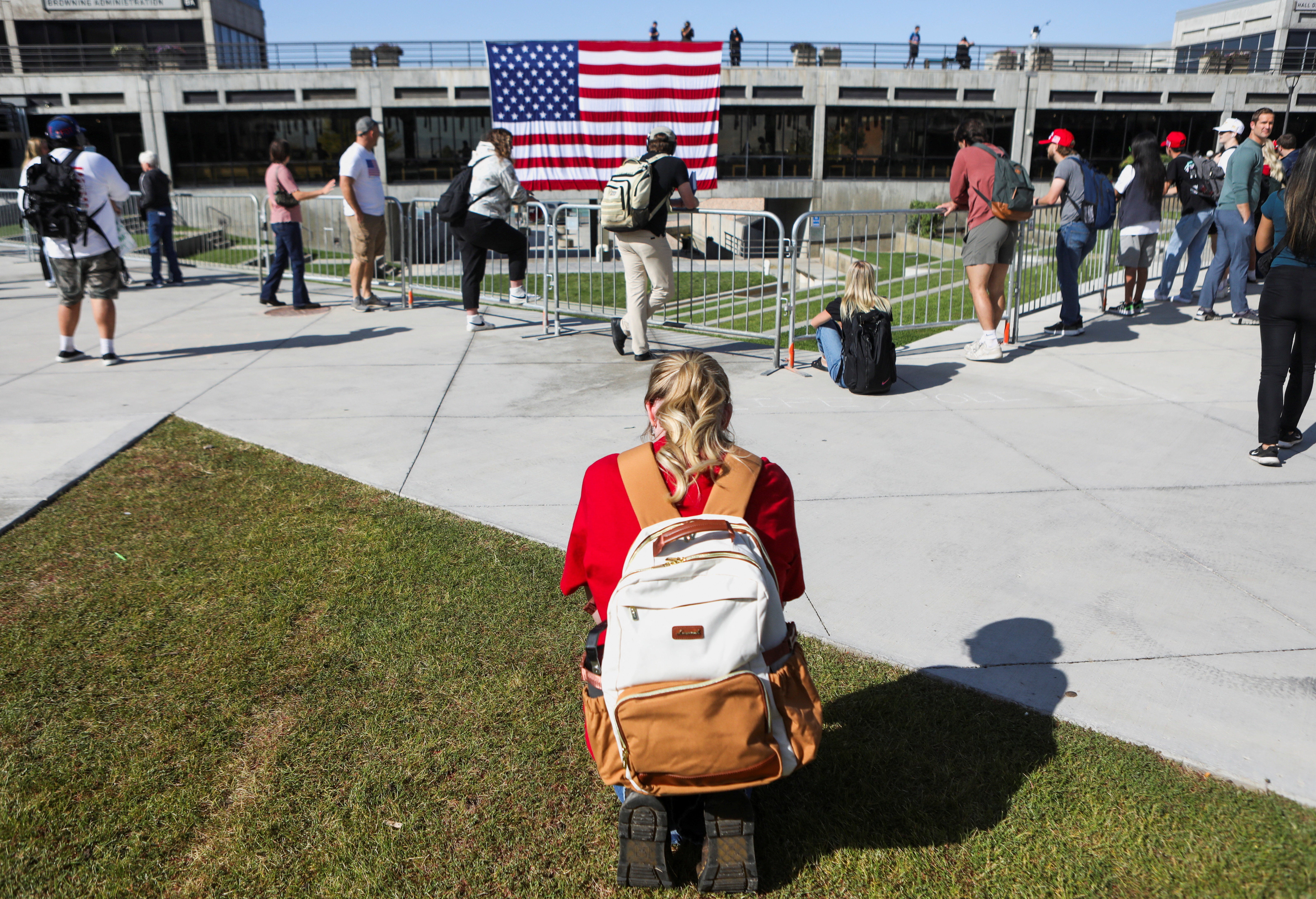 A woman prays at Utah Valley University, near the site where right-wing activist Charlie Kirk was shot and killed last week. Students returned to class on Wednesday for the first time since the shooting